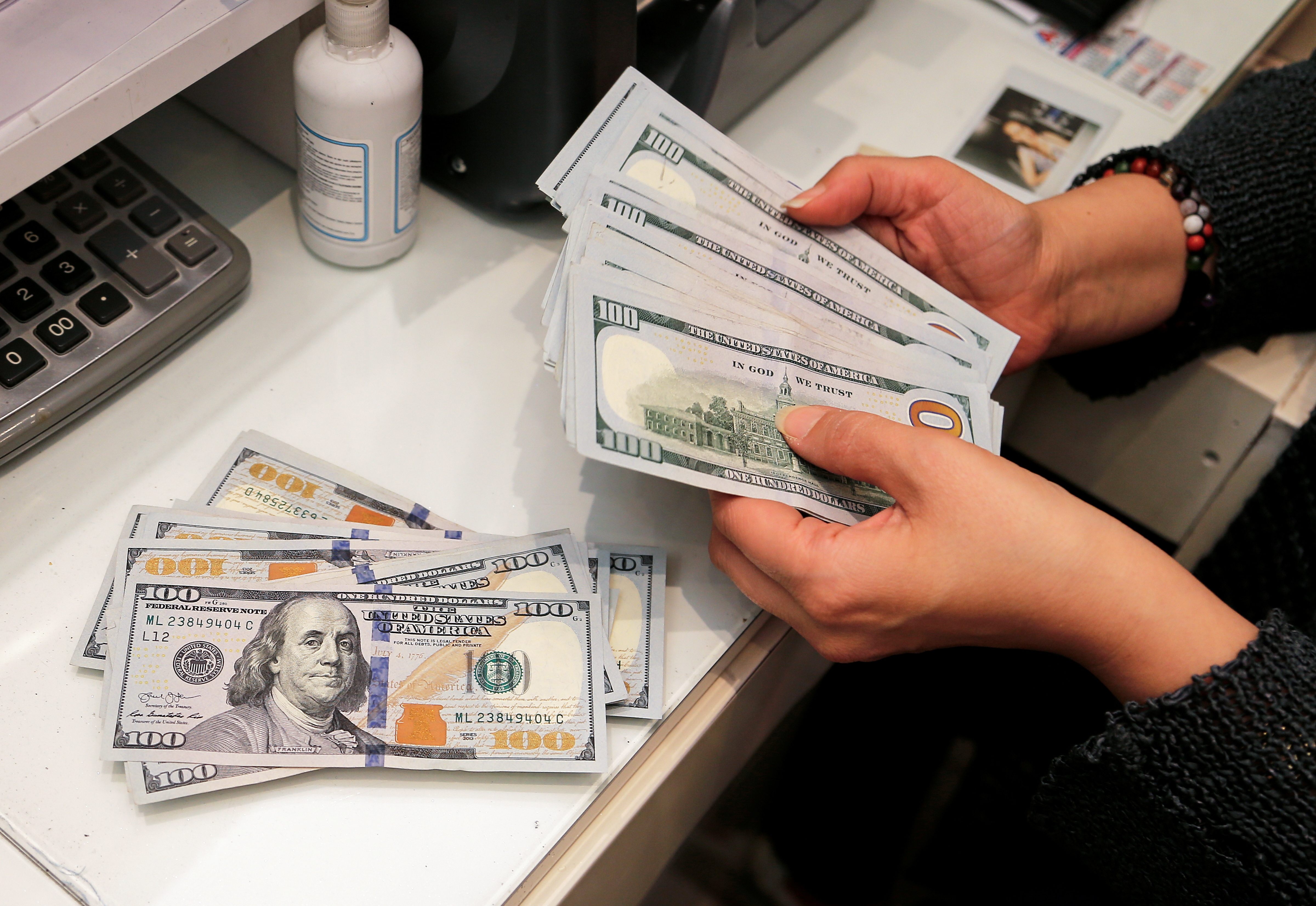 A money changer counts U.S. dollar banknotes at a currency exchange office in Ankara, Turkey on Oct. 12, 2021.