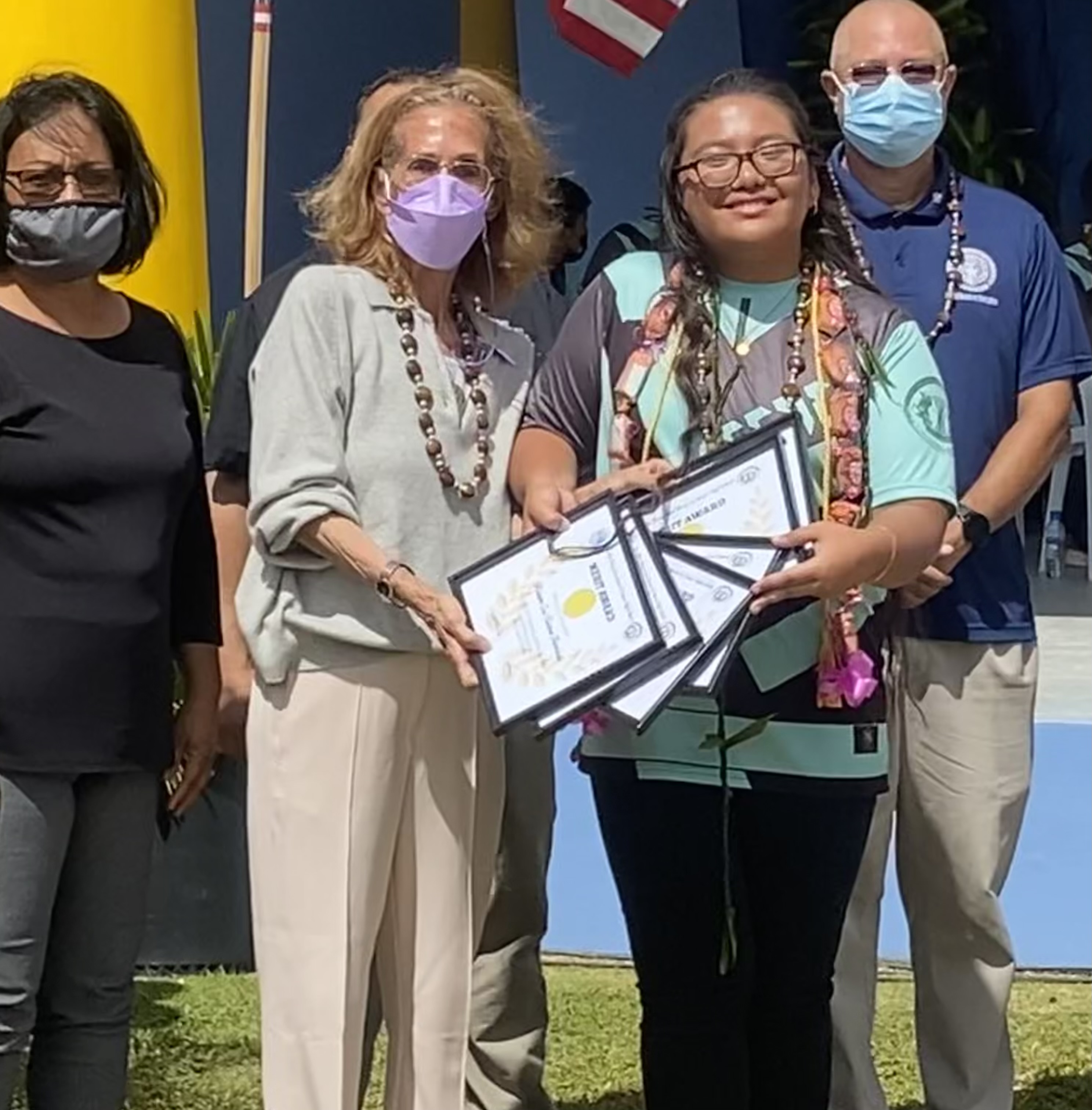 Junior high school valedictorian Rianna Isa Tuazon Barcinas receives the subjects awards for English, Language Arts, Math, Social Studies, Leadership Corps, Physical Education and Career Exploration-Fine Arts from School Principal D. Tanya King, Vice Principal Anette Calvo and BOE Chairman Gregory Pat Borja.