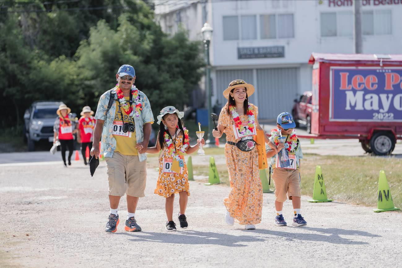 Brennan Chisato, left, and Shaina Chisato, second right,  win 1st  place in the Best Tourist Costume Contest during the Fit-to-Lead  Marianas  Tourism  Month Fun Run on May 14, 2022 in Garapan, Saipan.   