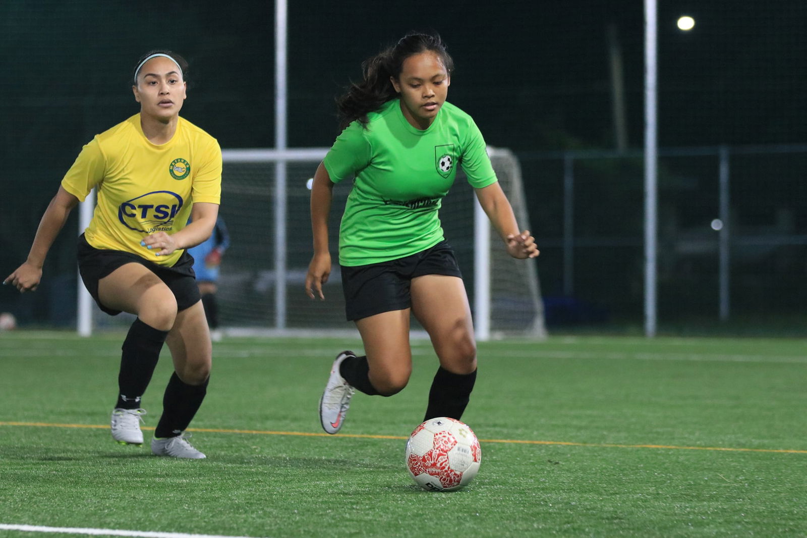 Mantasa's Chrishia Leon Guerrero, left, chases after a Tan Holdings player for the possession during an Intermediate Division, Group B game of the  Dove Women’s League at the NMI Soccer Training Center.