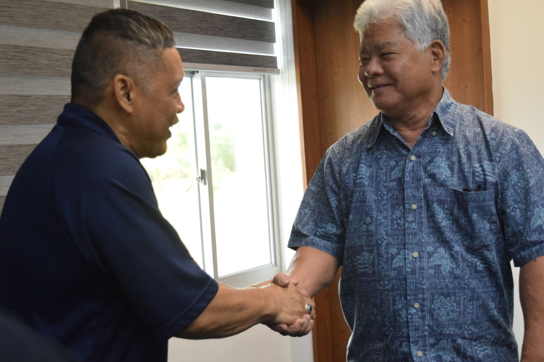Employer Support of the Guard and Reserve Guam-CNMI state chairman Ret. Lt. Col. Rey Llaneta, left, shakes hands with Lt. Gov. Arnold I. Palacios.