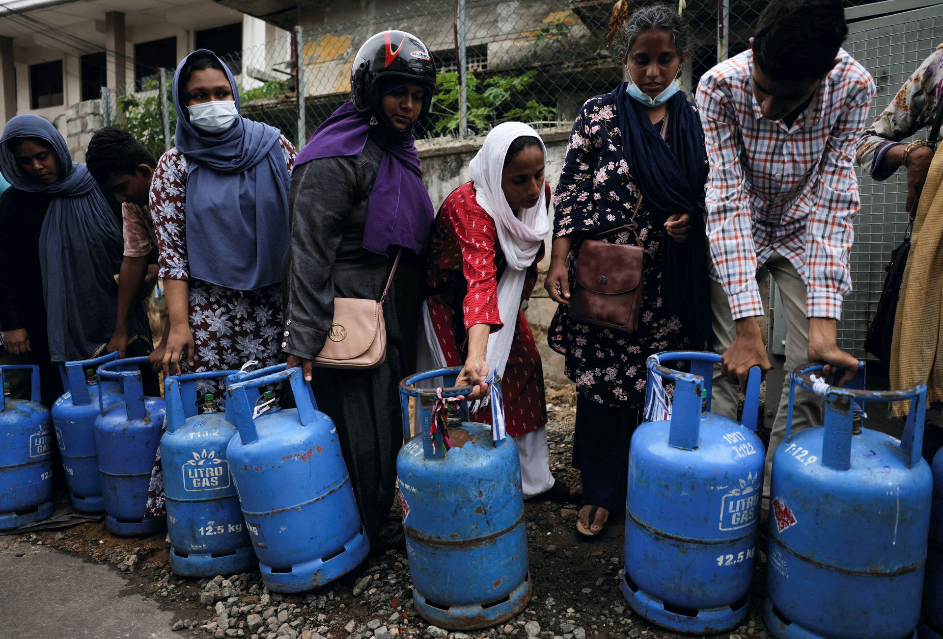 People wait in a line to buy domestic gas tanks near a distributor, amid the country's economic crisis, in Colombo, Sri Lanka, May 24, 2022.