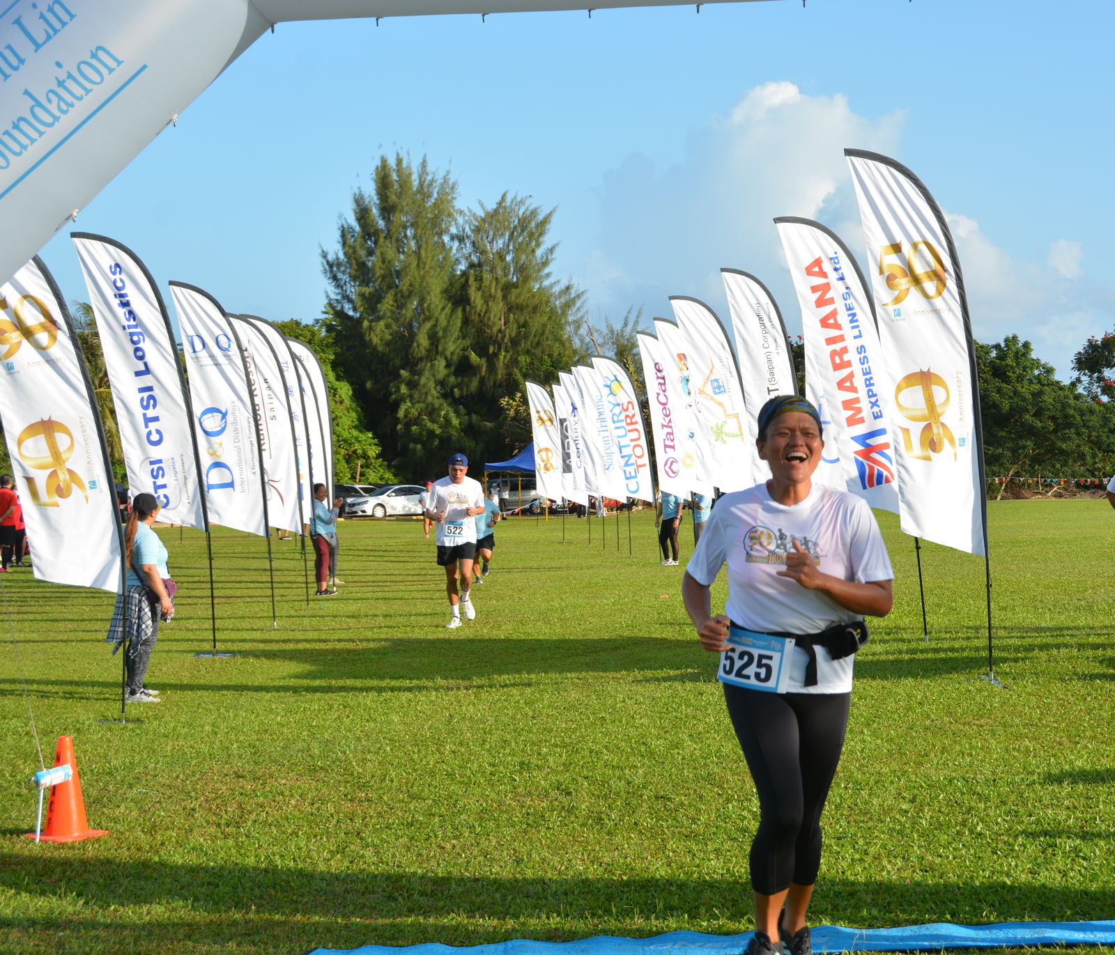 Runners head to the finish line of the Tan Holdings 50th Anniversary 10K Invitational Relay Run held Saturday at the Saipan golf course.