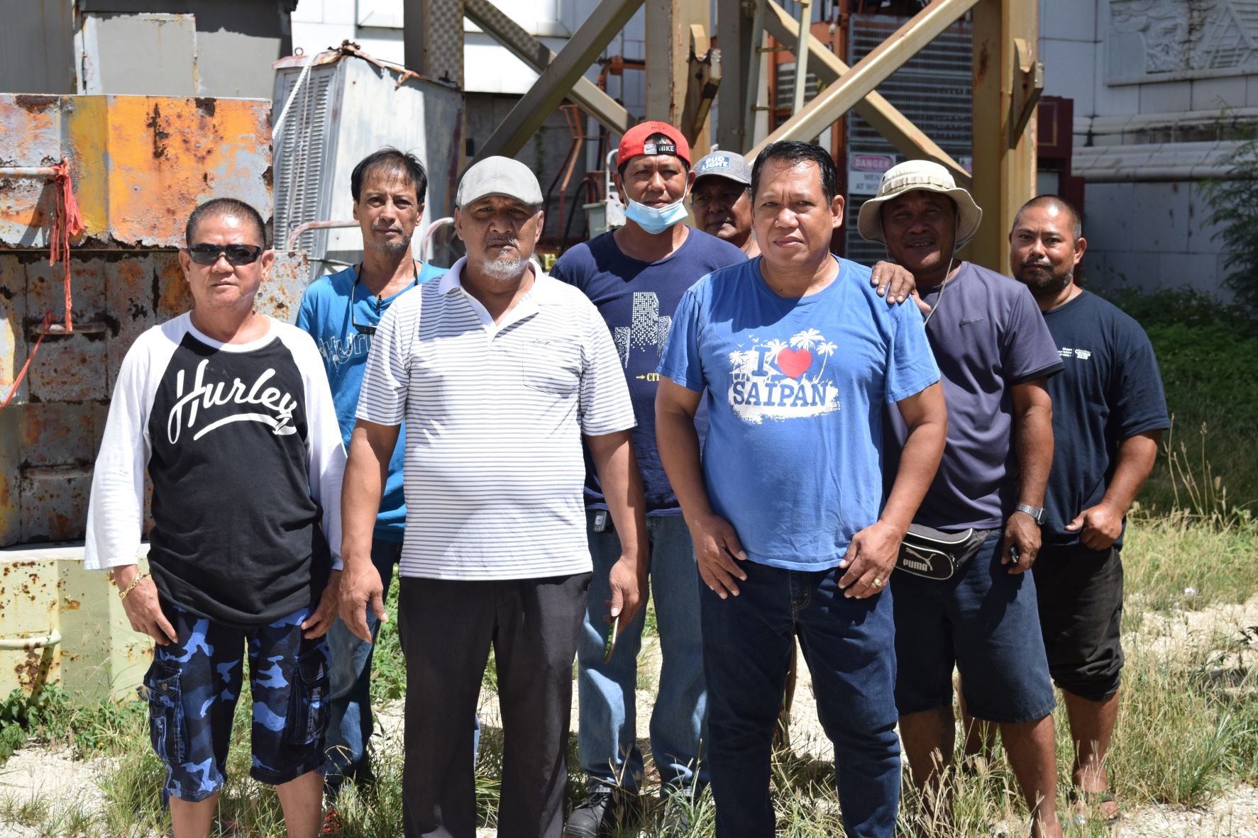 The members of the Imperial Pacific International construction team led by Jesse Aquiningoc, third left, stand next to their job site in Garapan on Wednesday: Electrician Apolinario Valiente, Mechanic Jonas Geronimo, Foreman Robert Valiente, Safety Officer Carlos Camacho, Crane Operator Willy Celeste, Riggers Chenty Apas and Noel Rios.