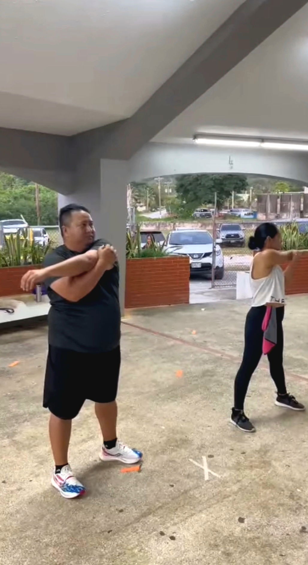 Gov. Ralph DLG Torres, left, and first lady Diann T. Torres, right, stretch before a Zumba session.