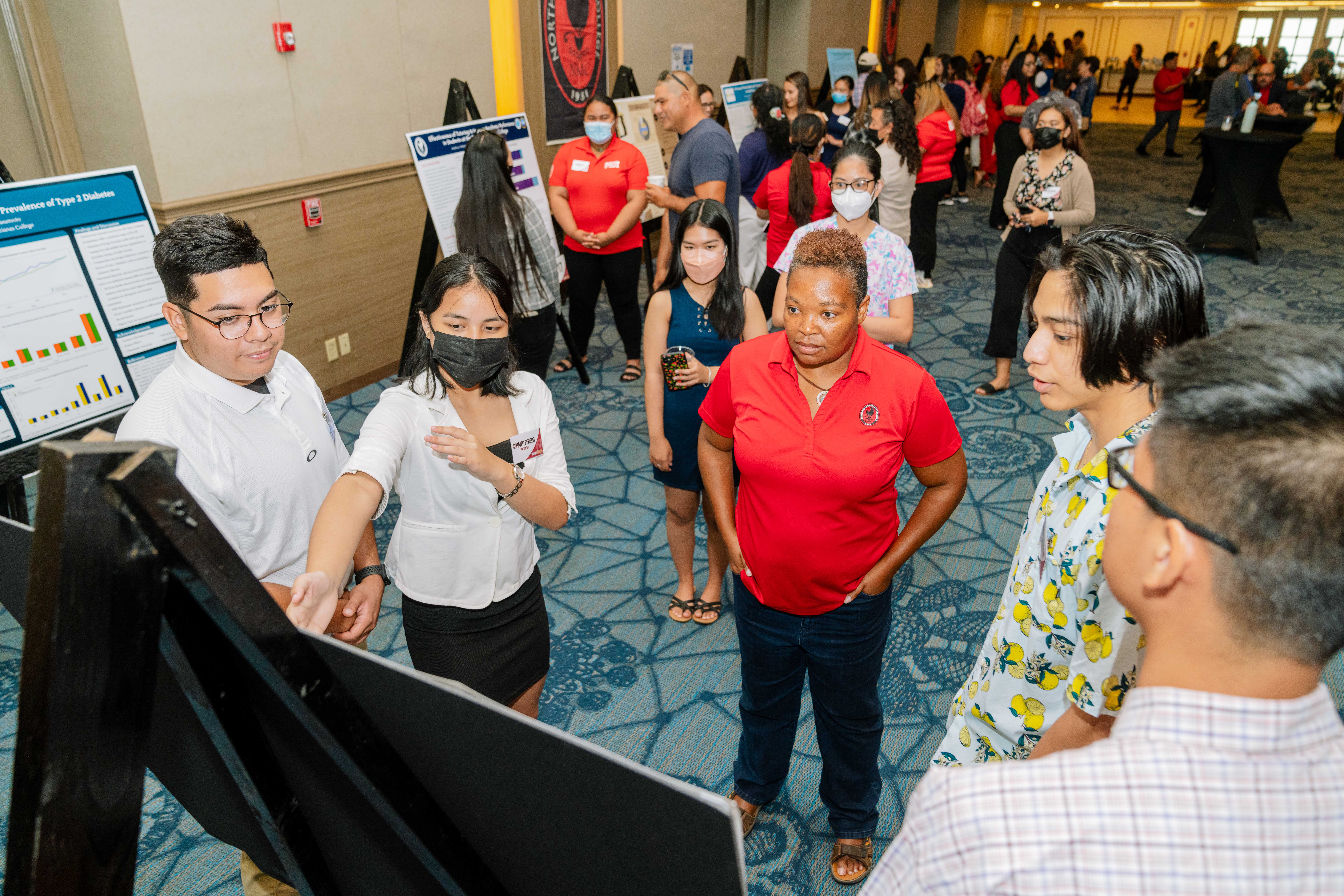 Northern Marianas College students Dimitri Sablan, Ashanti Peredo, Xue Qiu, Darlyn Ubarra, and Kiran Shrestha present their findings to audience members during NMC’s 2nd Annual Research Symposium held at the Saipan World Resort on April 29, 2022.
