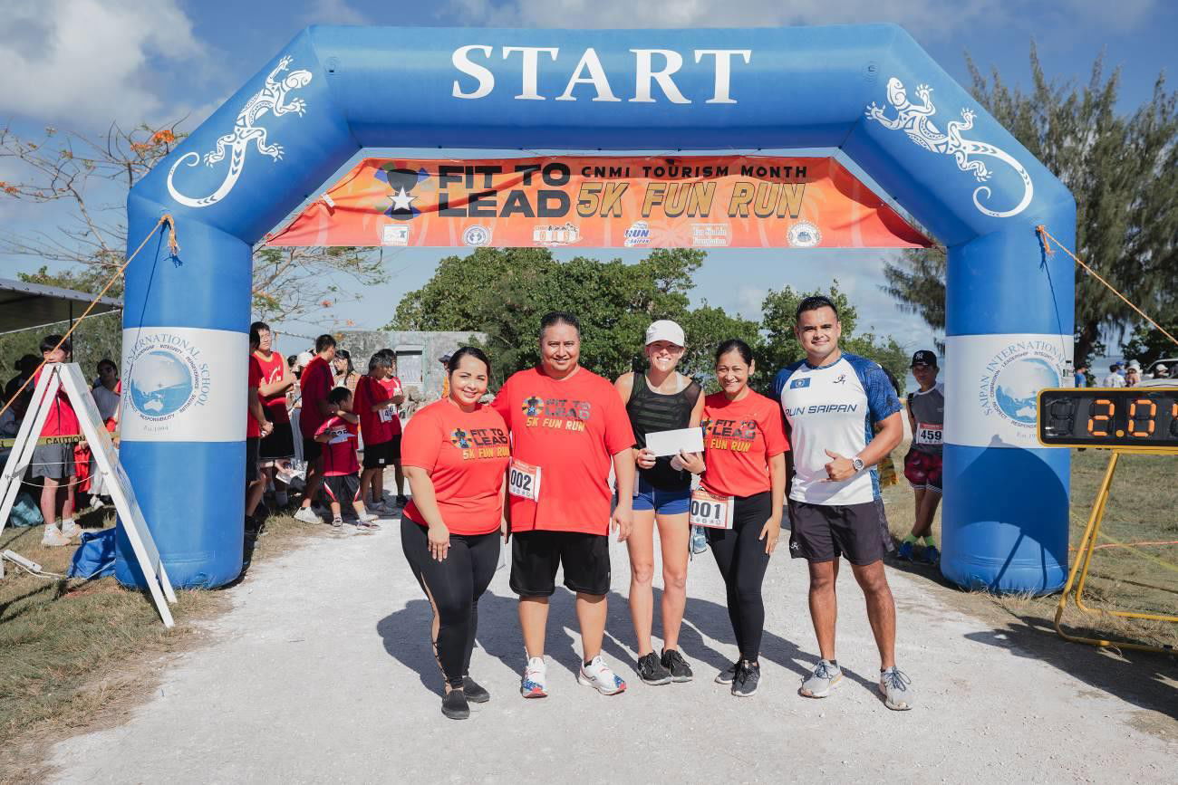 Denis Meyers, center, is awarded 2nd  place in the women's category of the Fit-to-Lead Marianas  Tourism  Month  Fun Run on  May  14, 2022 in Garapan, Saipan. From left, Marianas  Visitors  Authority  Managing  Director Priscilla  M.   lakopo, Gov. Ralph DLG Torres,  Meyers, first lady Diann Torres,  and Run Saipan President Edward Dela Cruz.