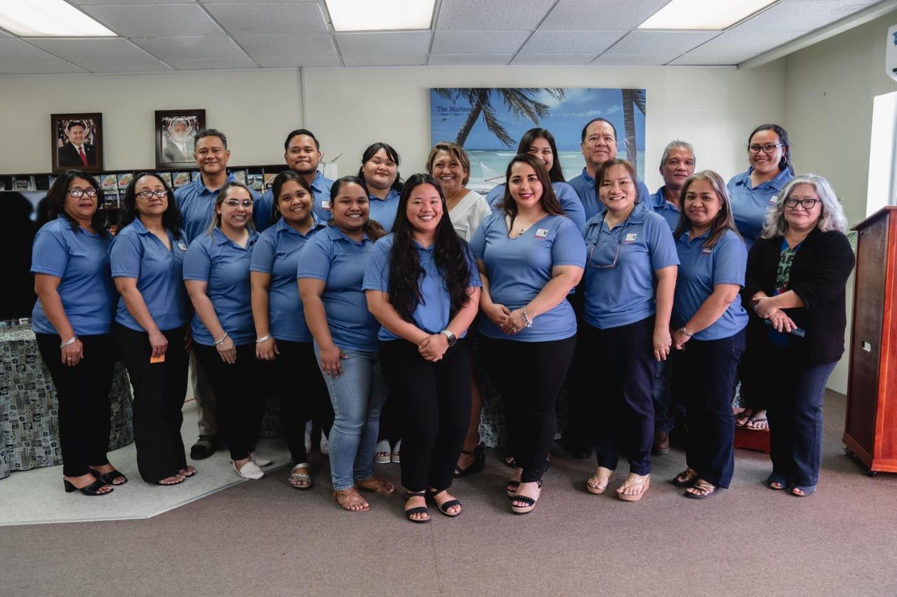 Staff and managers of Marianas Visitors Authority are congratulated by MVA Board  Vice  Chairwoman  Gloria  Cavanagh,  in  white,  and  MVA  Managing  Director Priscilla M. Iakopo, eighth from right, as they receive their service awards on May 5, 2022, at the MVA office in San Jose, Saipan, during Public Service Recognition Week.