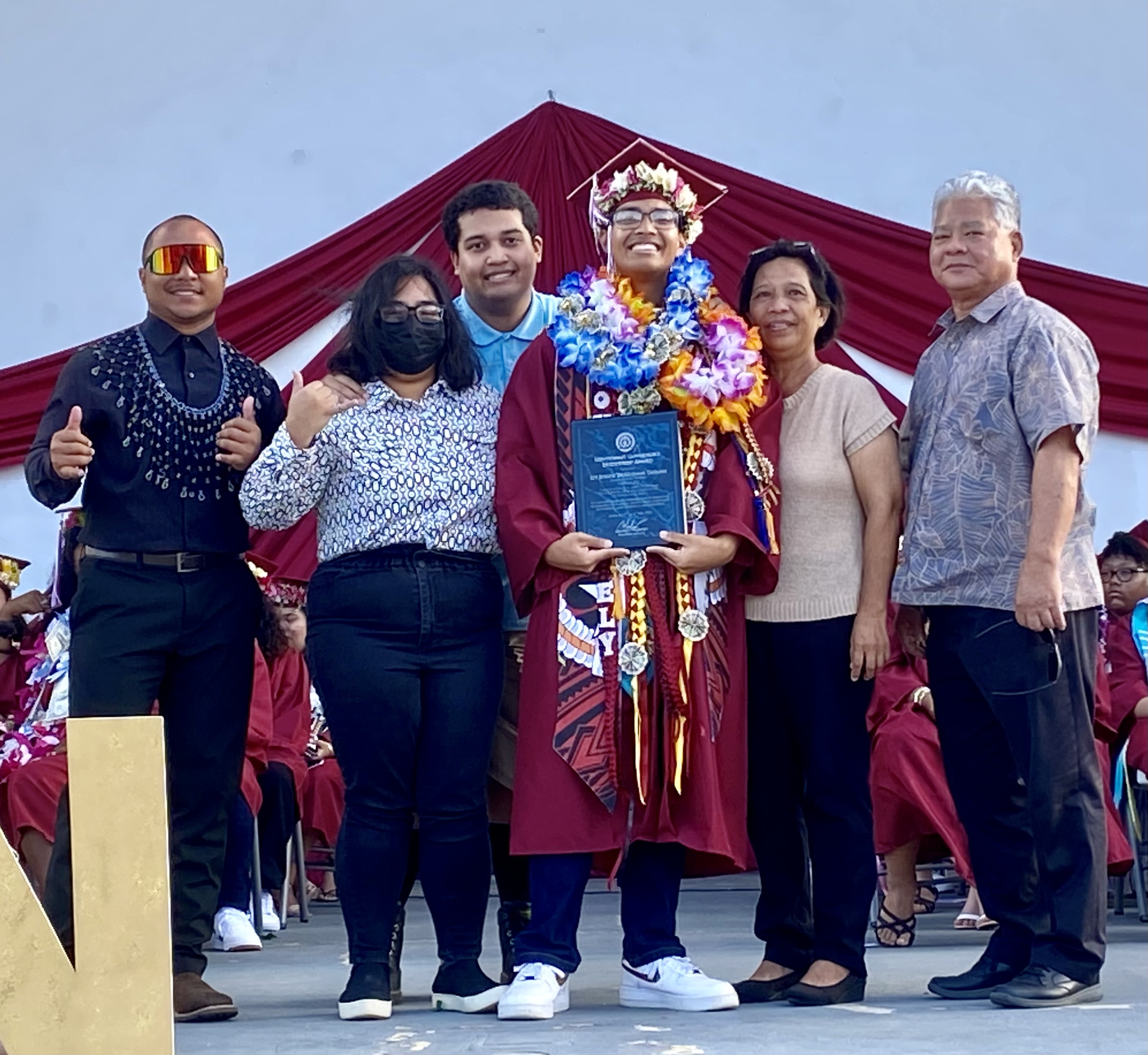 Lt. Gov. Arnold I. Palacios presents the Lt. Governor’s Award to Ely Joseph De Guzman Taitano. Also in photo is Taitano’s parents.