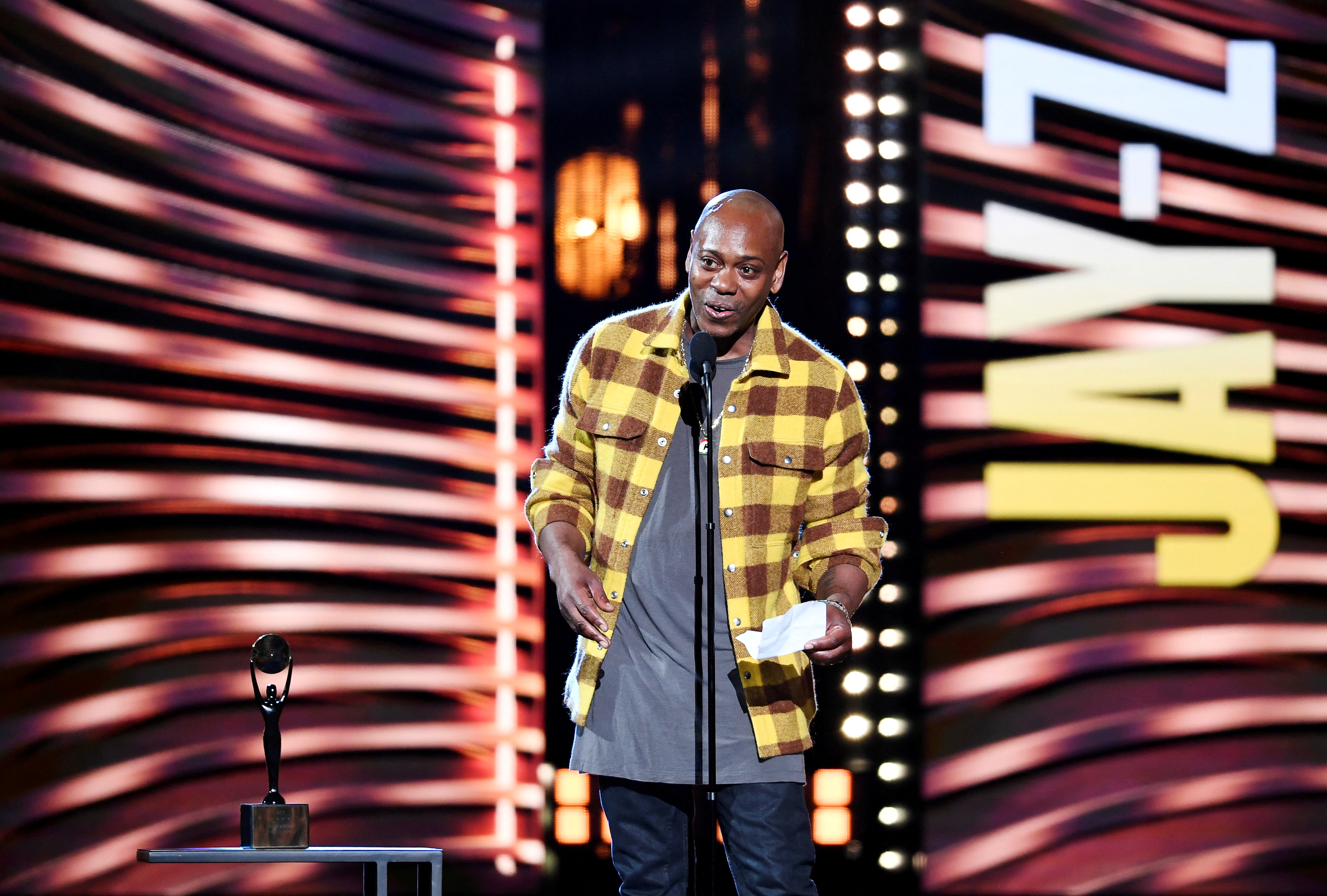 Dave Chappelle introduces Jay-Z during the Rock and Roll Hall of Fame induction ceremony in Cleveland, Ohio, Oct. 30, 2021.