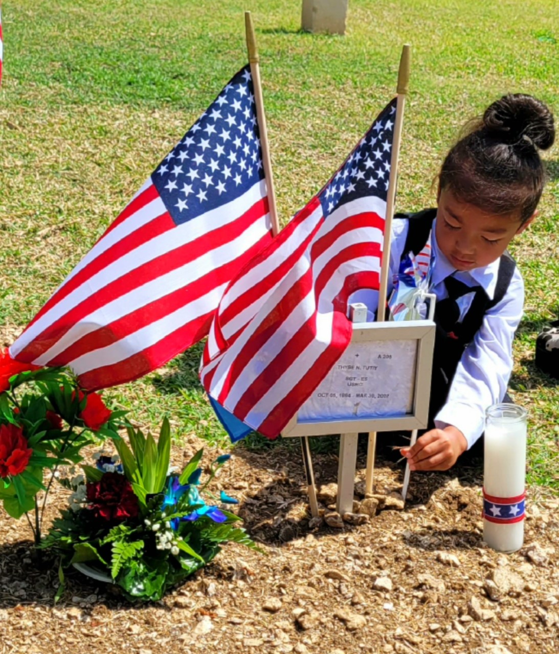A boy pays tribute to his father, a fallen hero.