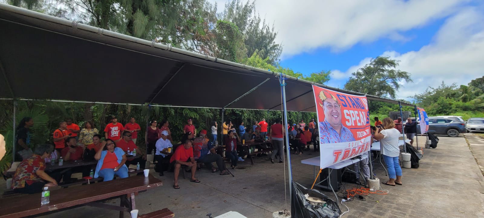 Supporters of Gov. Ralph DLG Torres are seen at a canopy outside the legislative building on Capital Hill, Friday morning, as the Senate begins its impeachment hearing.