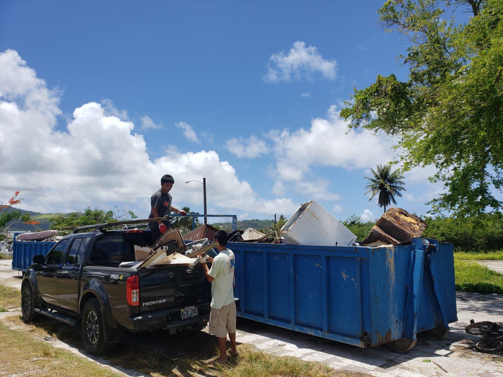 Residents off-load  their trash into the bins provided by the offices of Reps. Tina Sablan and John Paul Sablan during the Precinct 2 Spring Cleanup in Chalan Kanoa Saturday, May 21, 2022.