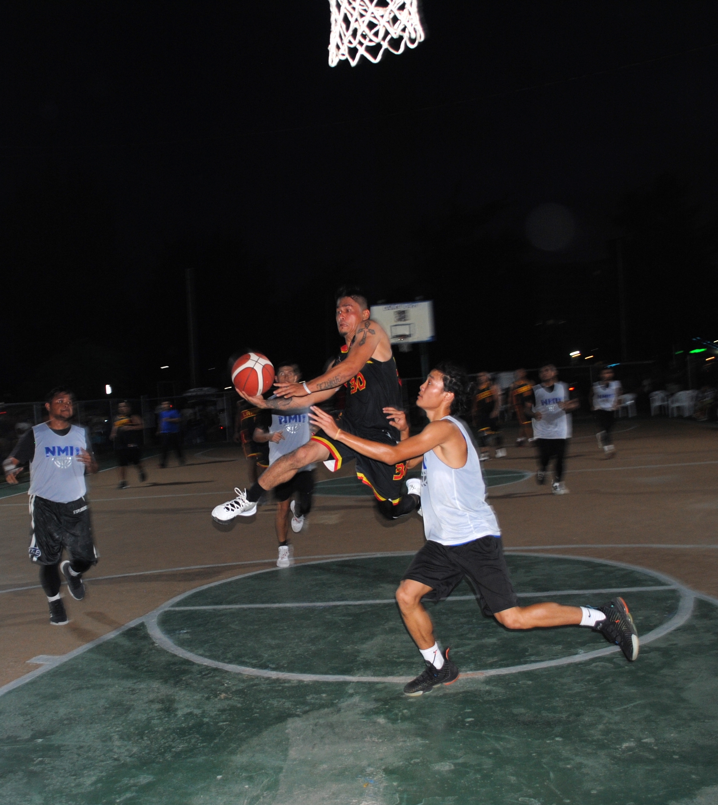 Lakay/Islander's Palacios attempts the scoop layup.