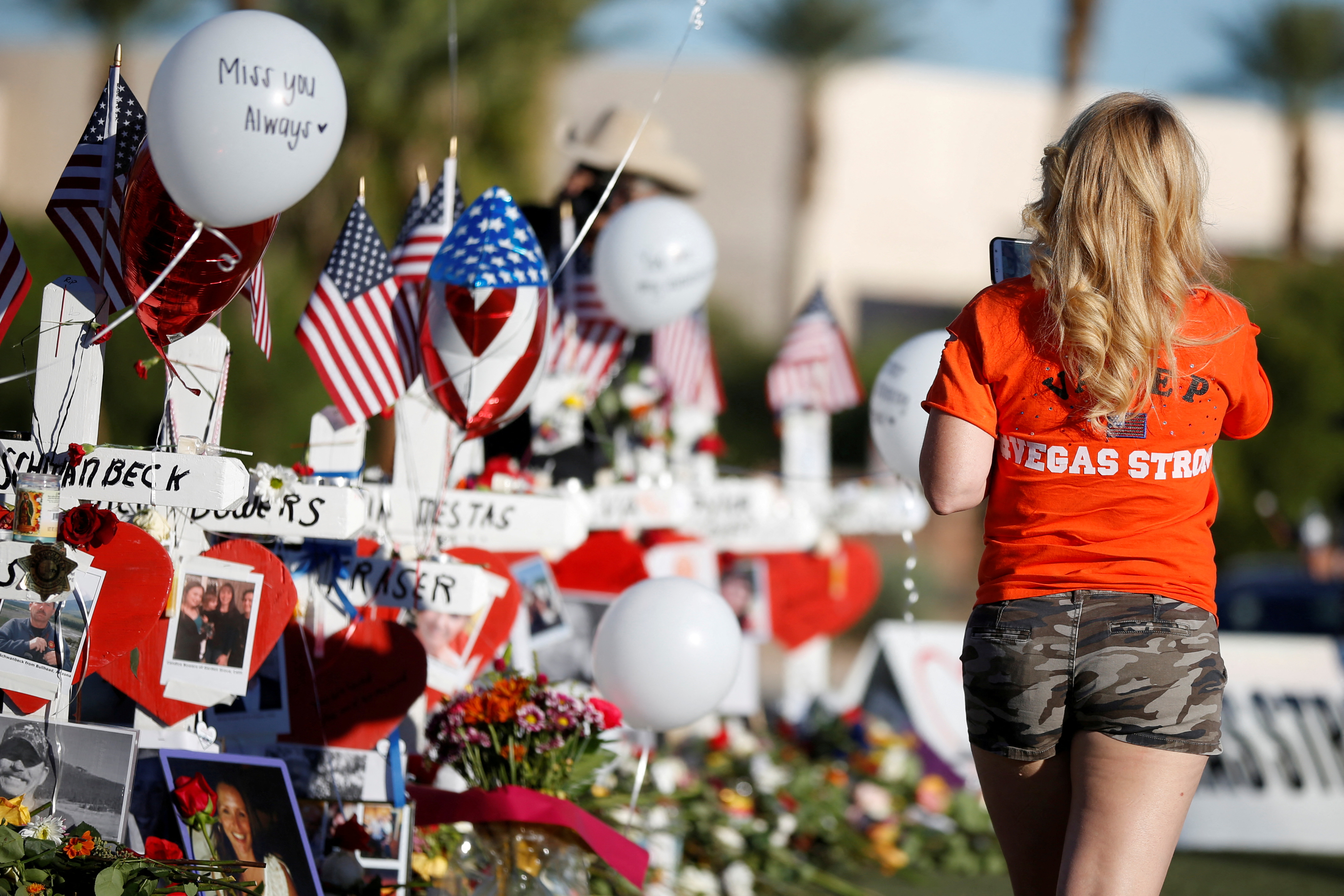 A woman looks at white crosses set up for the victims of the Route 91 Harvest music festival mass shooting in Las Vegas, Nevada, Oct. 7, 2017.
