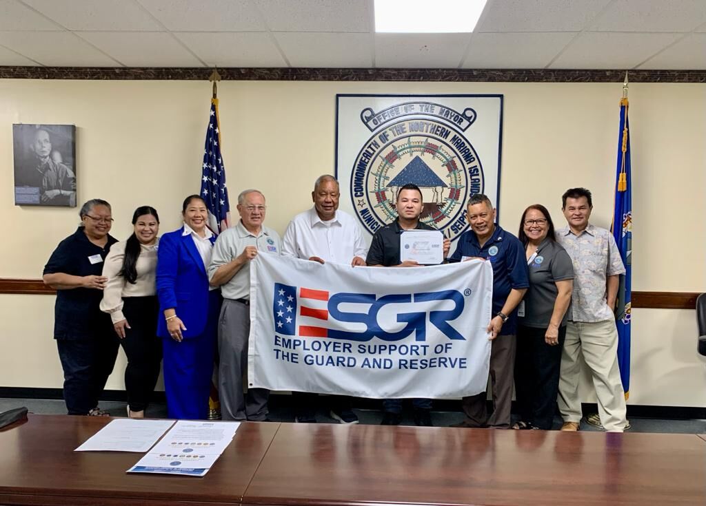 Office of Saipan Mayor's Dog Control Program Coordinator Martin Pangelinan fourth right, holds his Patriotic Award as he poses for a photo with Saipan Mayor David M. Apatang, Employer Support of the Guard and Reserve Guam-CNMI state chairman Ret. Lt. Col. Rey Llaneta, vice chair Ret. Maj. Gen. Benny Paulino, volunteer support technician Angel D. Vibar, Guam-CNMI area chair Rita A. Sablan, Ed.D., ombudsman Joann Aquino, employer outreach coordinator Rose Igitol and special assistant to Saipan mayor Henry Hofschneider in the mayor's office conference room on May 4, 2022.