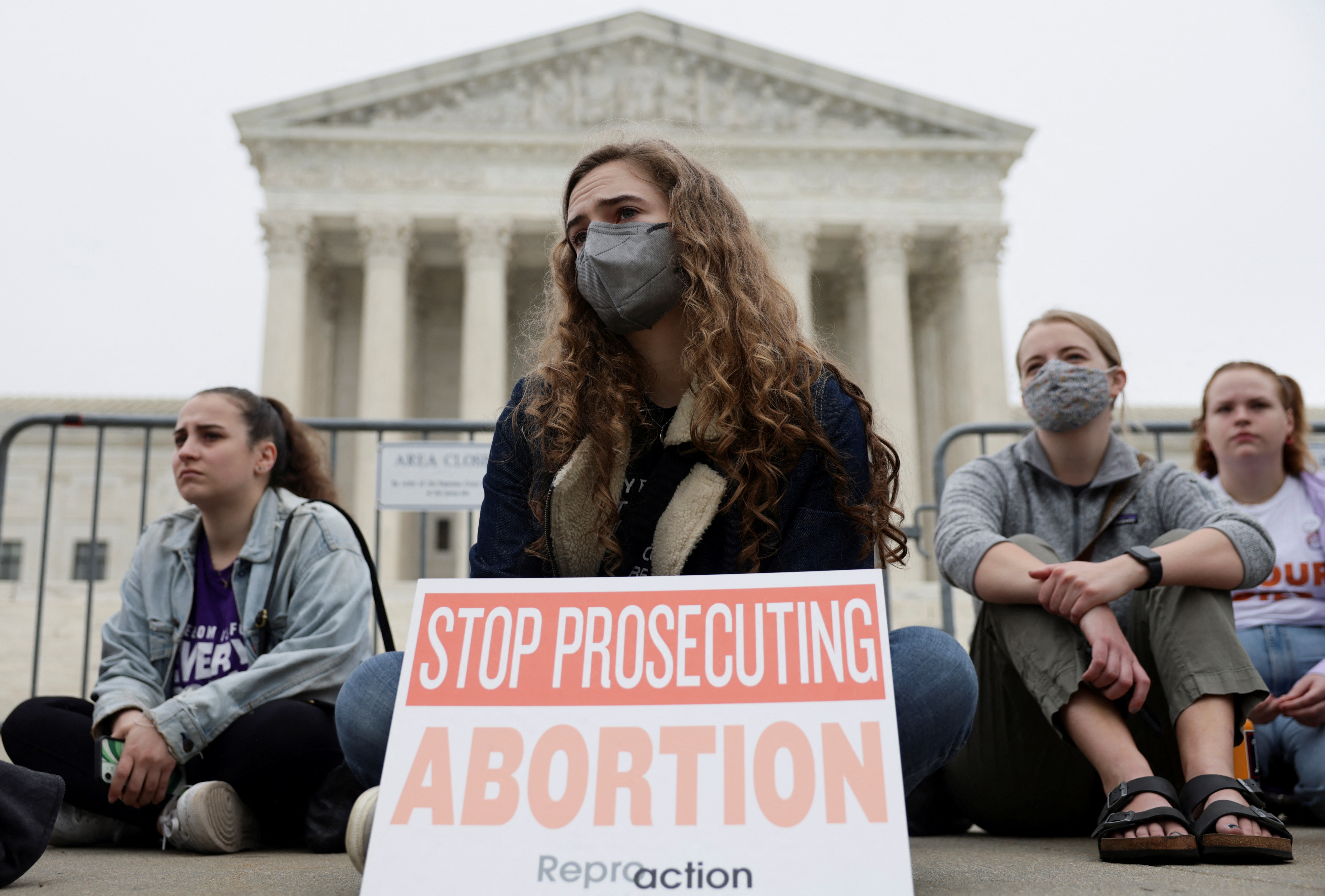Protestors sit outside the U.S. Supreme Court after the leak of a draft majority opinion written by Justice Samuel Alito preparing for a majority of the court to overturn the landmark Roe v. Wade abortion rights decision later this year, in Washington, D.C., May 3, 2022.
