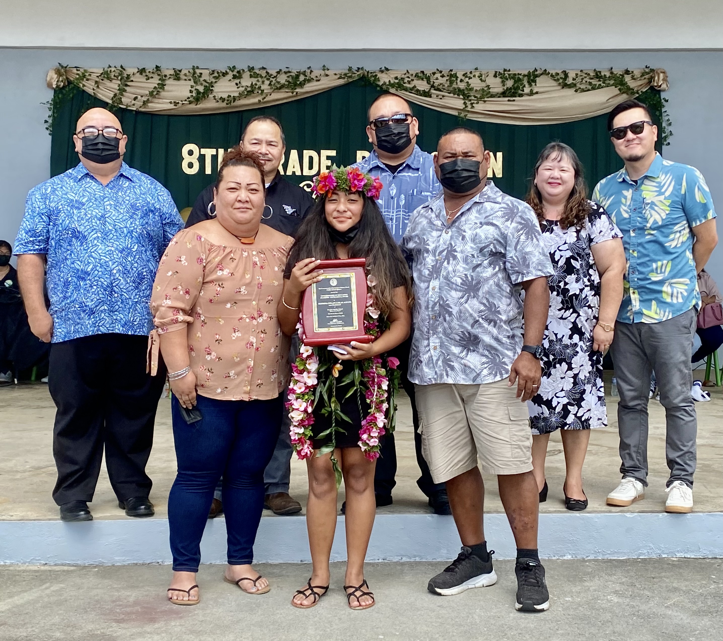 Class salutatorian and Commissioner of Education awardee Herminia Kolani Sablan Agulto poses for a photo with  her mother, Marianas High School Vice Principal Melanie Sablan Rdiall, father, Paython, and Public School System officials led by Education Commissioner Dr. Alfred B. Ada, Associate Commissioner for Administration Eric Magofna, Senior Director Dr. Rizalina Liwag, Principal James Sablan and Vice Principal Reo Arriola.
