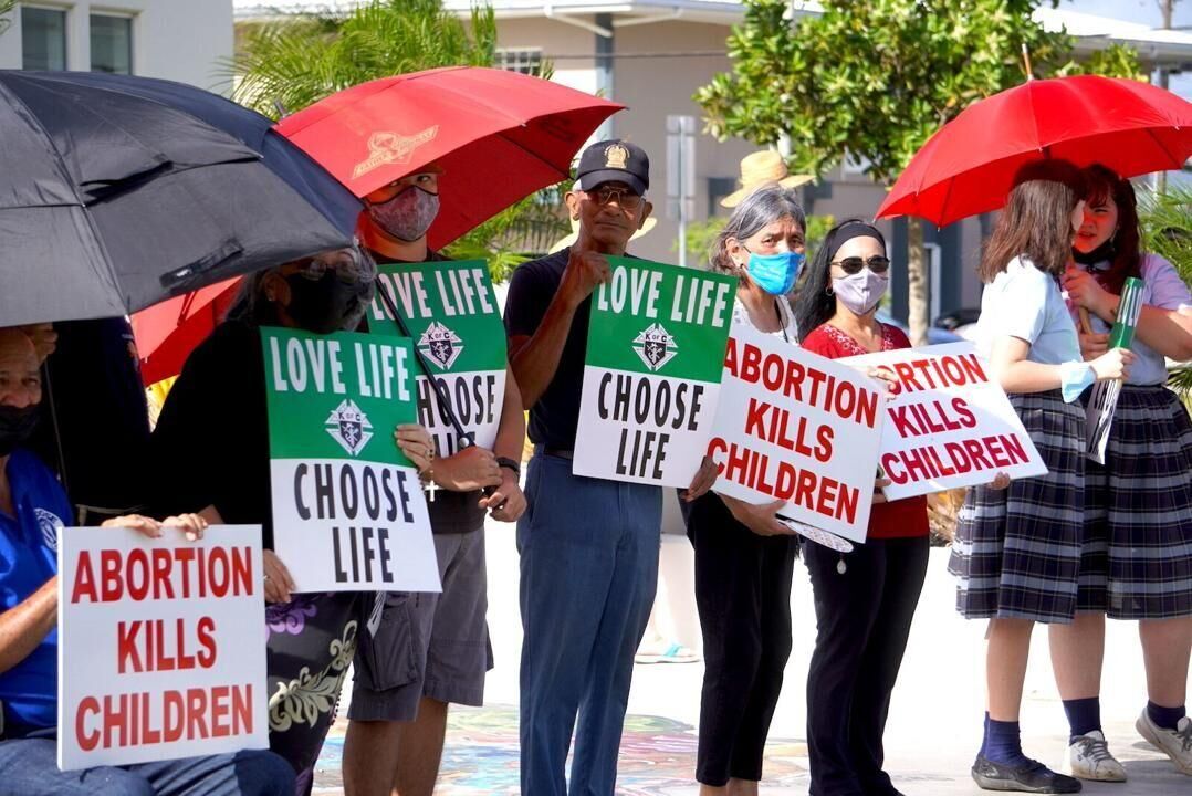 Anti-abortion protesters gather Tuesday outside the Guam Congress Building in Hagåtña. Lawmakers have introduced the Guam Heartbeat Act of 2022, or Bill 291, which would ban abortions once a fetal heartbeat is detected — about six weeks into a pregnancy.
