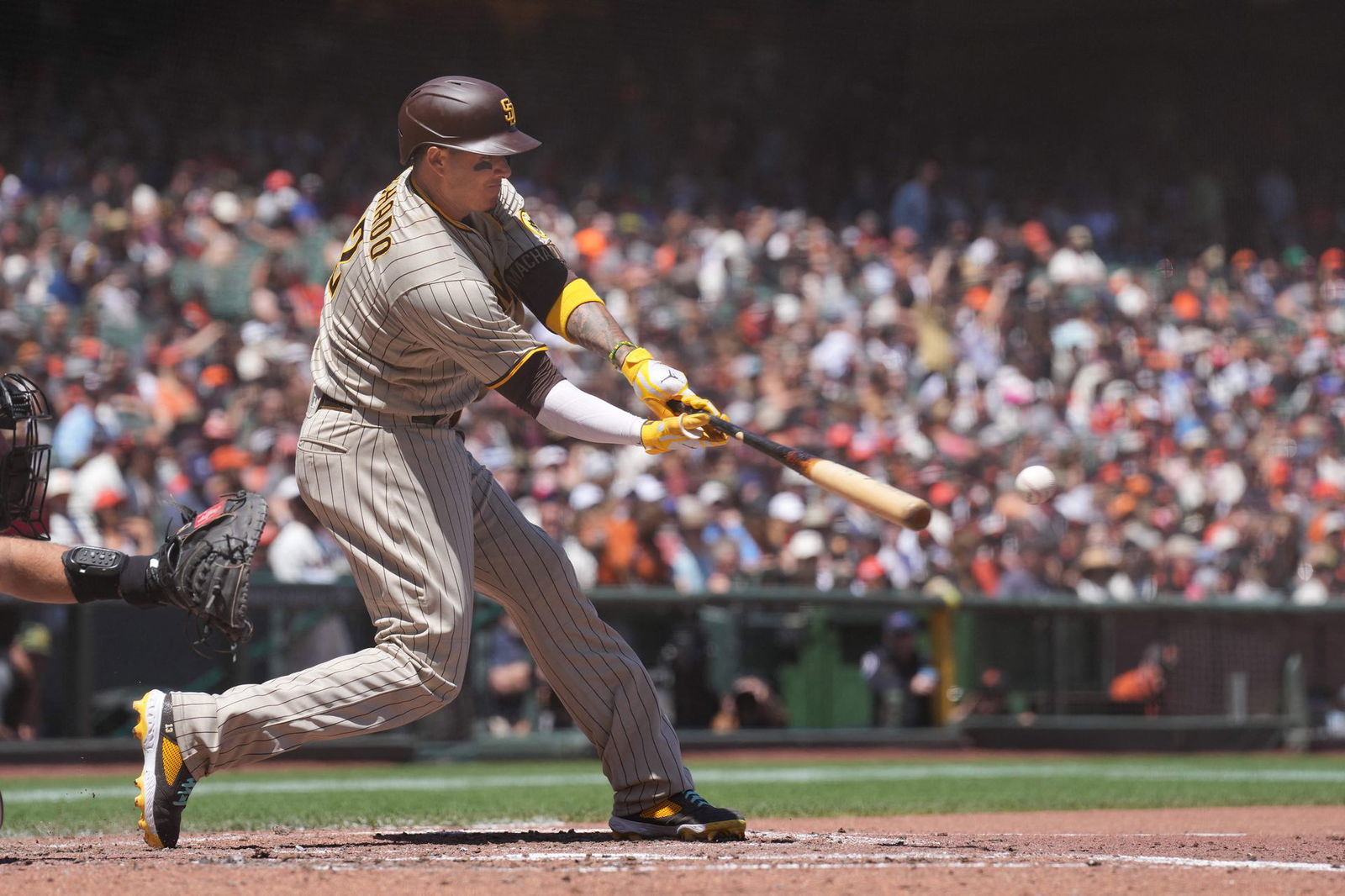 San Diego Padres third baseman Manny Machado (13) hits an RBI double against the San Francisco Giants during the fourth inning at Oracle Park in San Francisco, California on May 22, 2022.