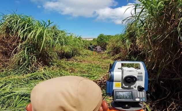 DPL surveyors conducting retracement of lot behind Ada gym in preparation of the Pacific Mini Games.