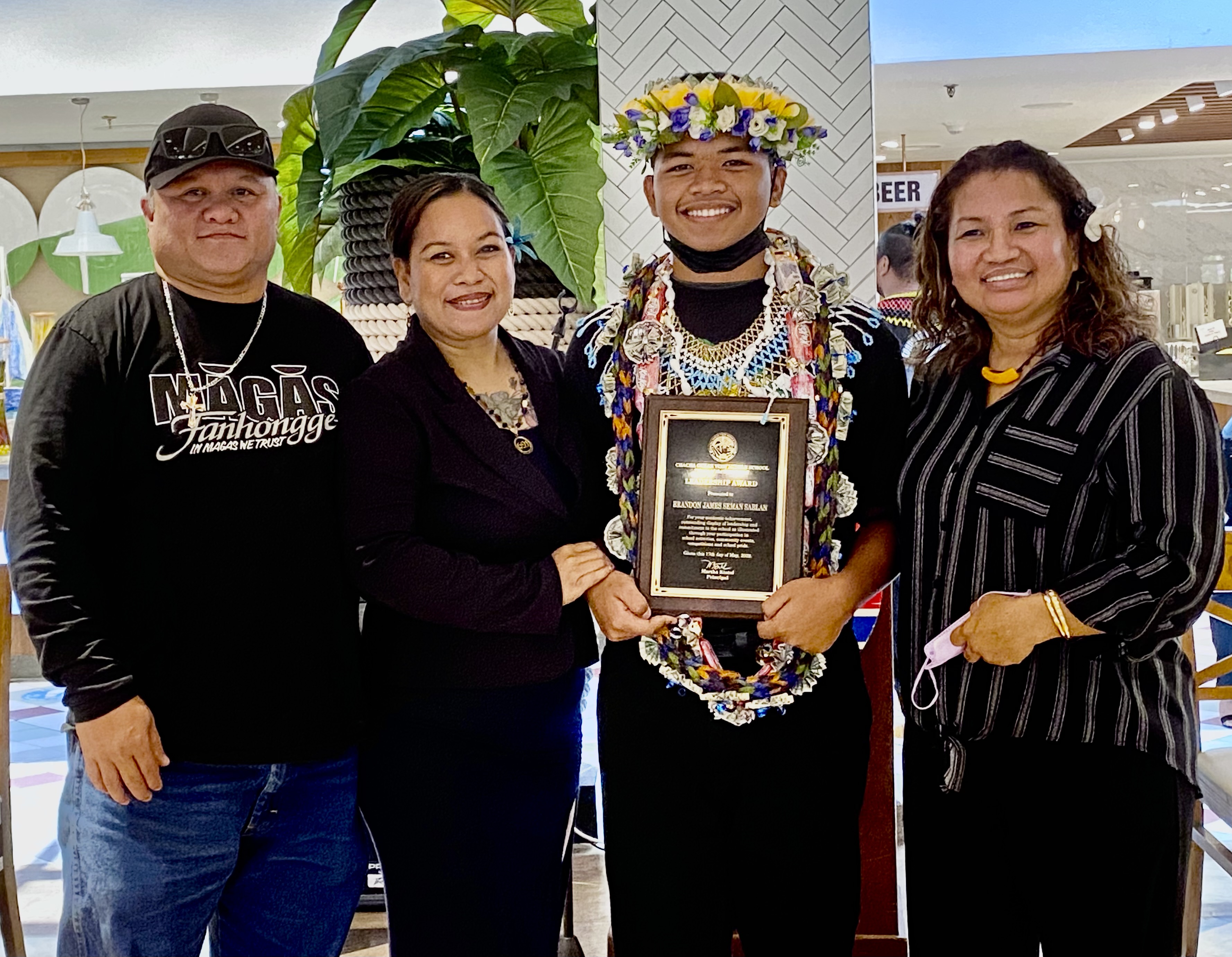 Chacha Leadership awardee Brandon James Seman Sablan poses for a photo with his parents and Principal Martha Kintol.