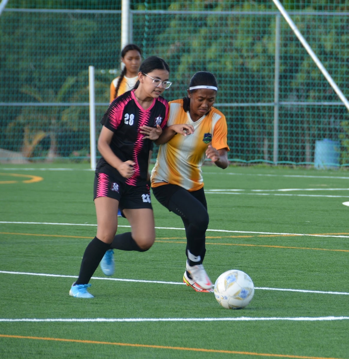 Kanoa’s Kaithlyn Chavez battles for the possession during a U16 girls division game of the TakeCare Youth Soccer League at the NMI Soccer Training Center.