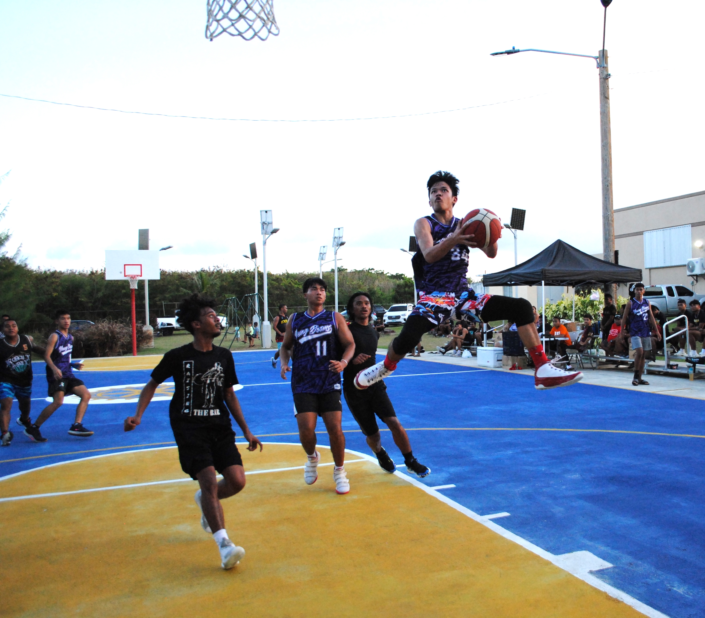 Young Doom's Craig Padayao attempts the double-clutch layup.