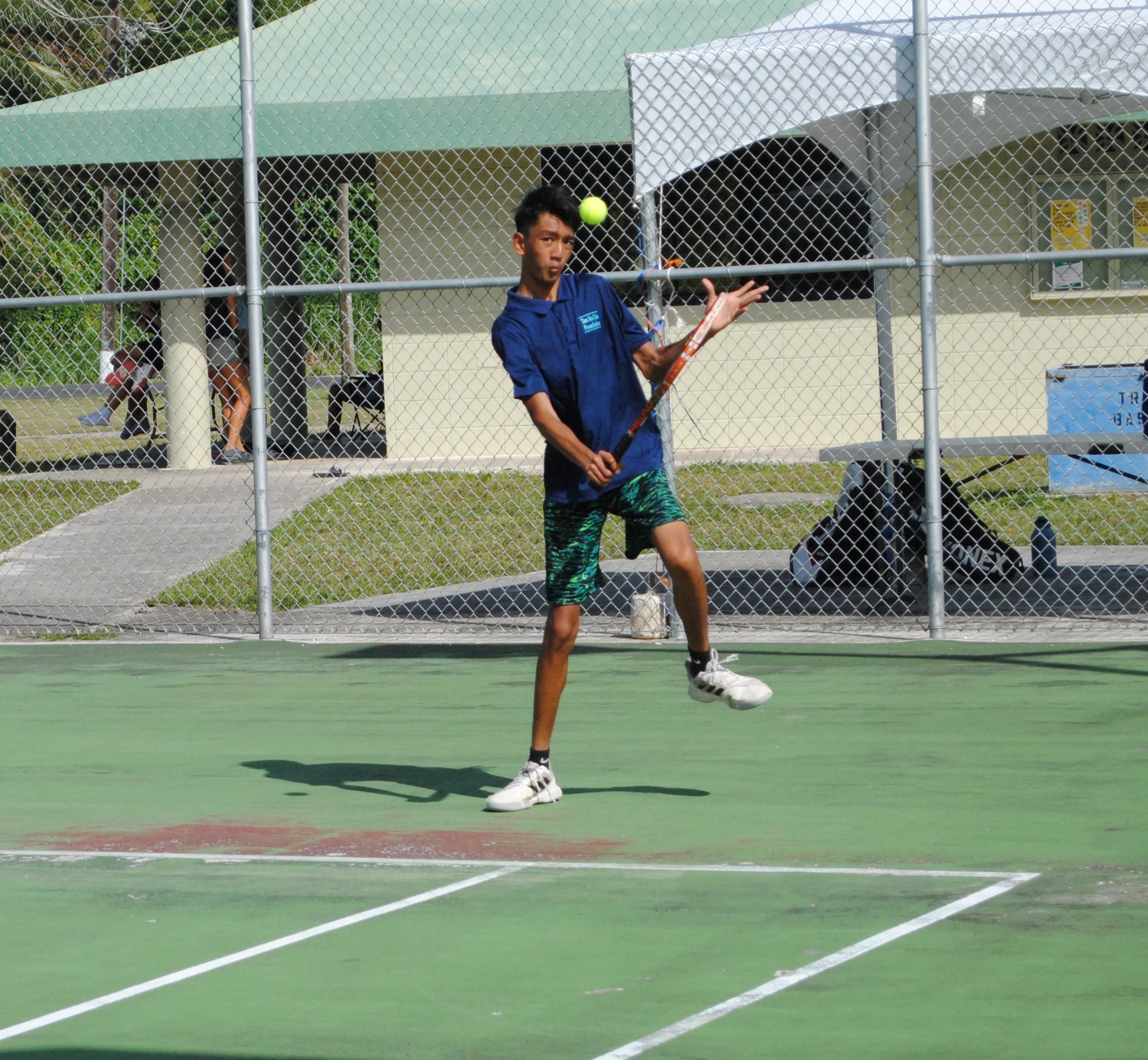 Simon Tang makes the adjustment for the return during a TSL CNMI Junior Tennis Tournament game on Sunday at American Memorial Park.