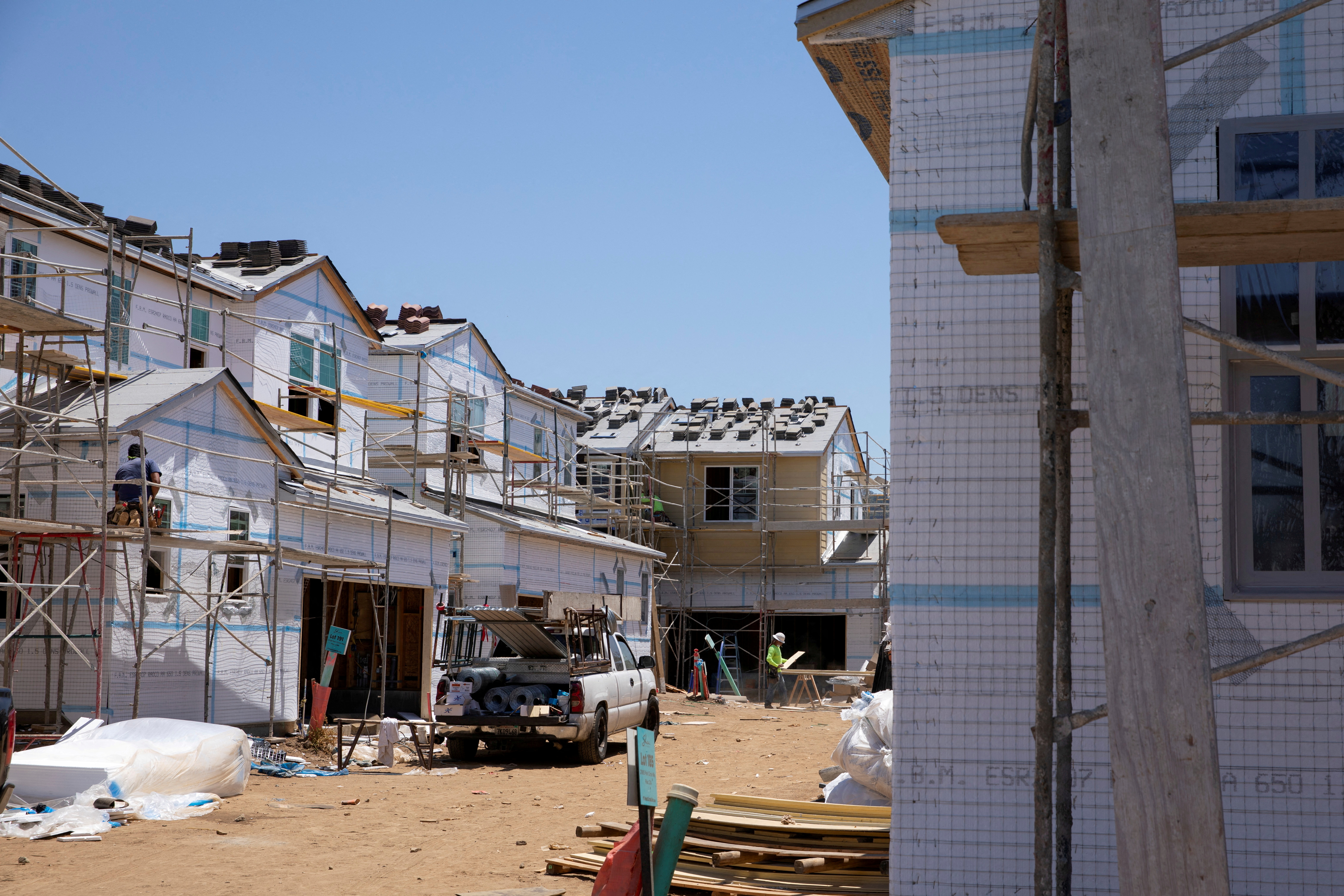 Residential single family homes construction by KB Home are shown under construction in the community of Valley Center, California on June 3, 2021.