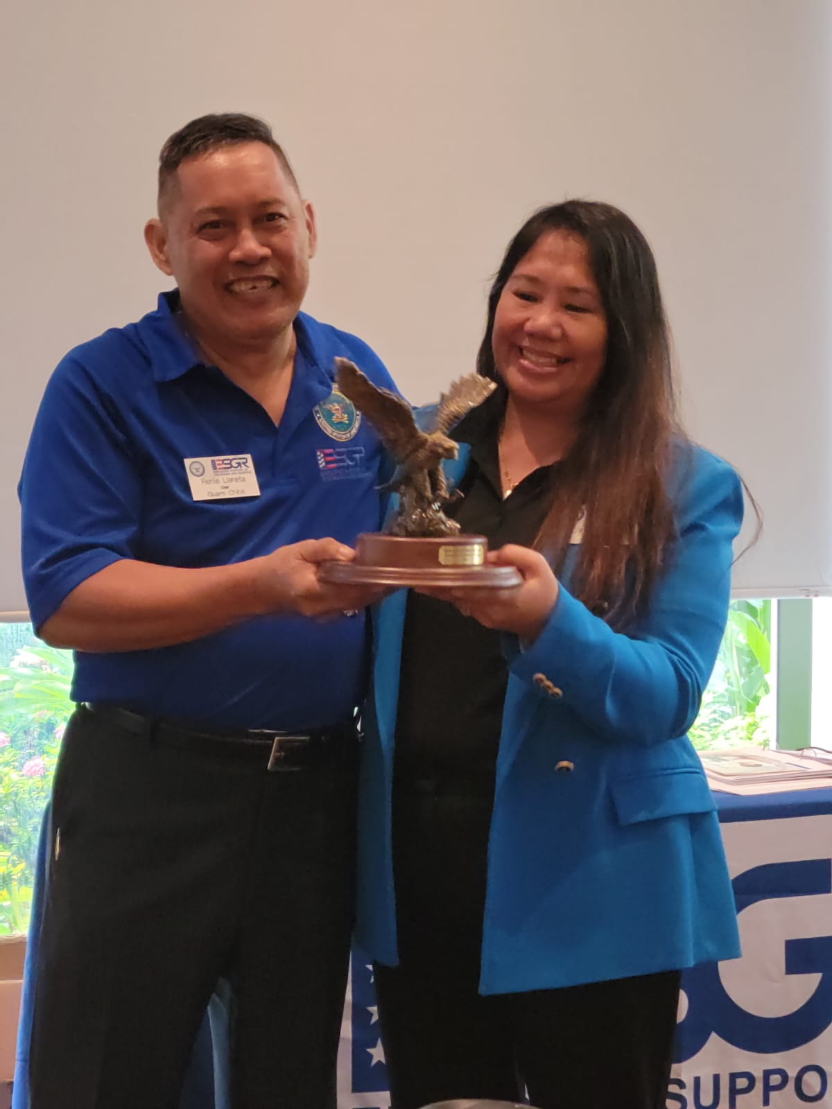 Employer Support of the Guard and Reserve Guam-CNMI state chairman Ret. Lt. Col. Rey Llaneta hands the Guam-CNMI ESGR State Committee Volunteer of the Year Award to ESGR ombudsman Joann Aquino who also serves as field operations director of the Saipan Mayor's Office.