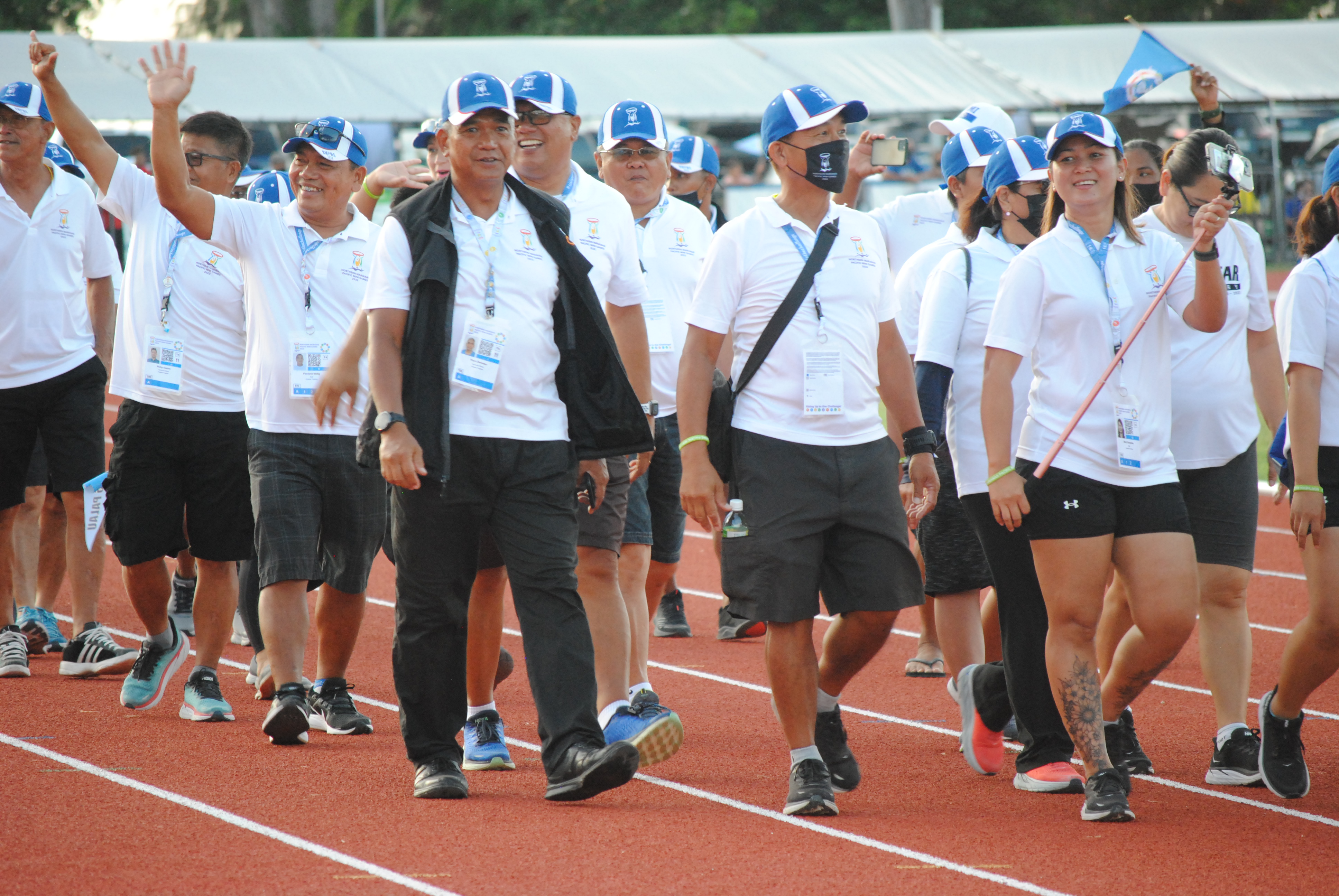 The NMI triathlon team members make their way at the Oleai Track & Field during the closing ceremony.