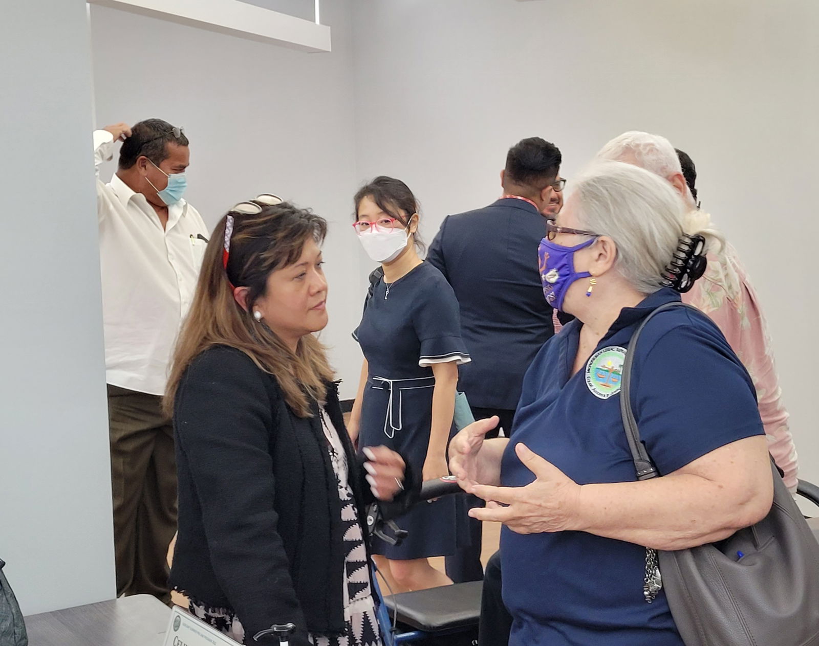Law Professor Rose Cuison-Villazor listens to local attorney Jane Mack in the Guma Hustisia Assembly Hall.