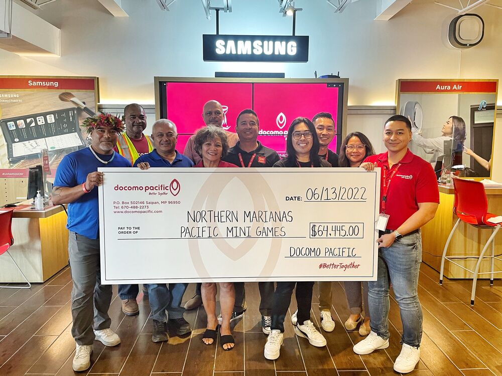 A Gold Sponsorship presentation to the 2022 Northern Marianas Pacific Mini Games. In photo: Marco Peter, chairman, PMG Organizing Committee, left; Vicente Babauta, chief executive officer, PMG Organizing Committee, third left; Pauline Johnson, general manager, Docomo Pacific, fourth left; and Brent Deleon Guerrero, CNMI brand manager, Docomo Pacific, far right; along with Docomo Pacific management team members.
