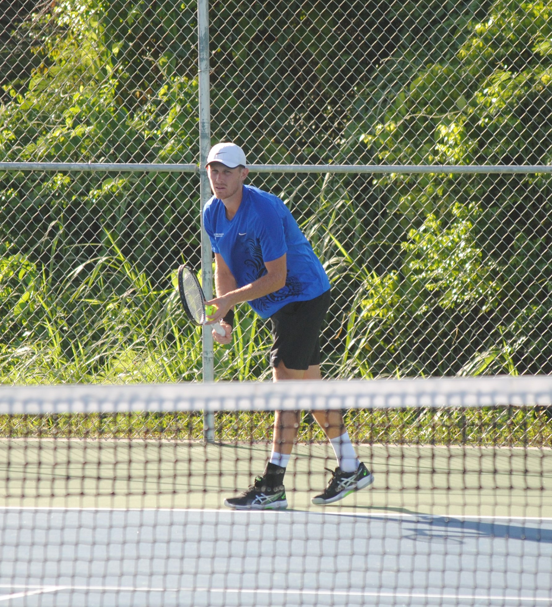 The NMI's Colin Sinclair sets up for the serve during the Men's Singles tennis finals of  the 2022 Pacific Mini Games at an American Memorial Park tennis court on Saturday.