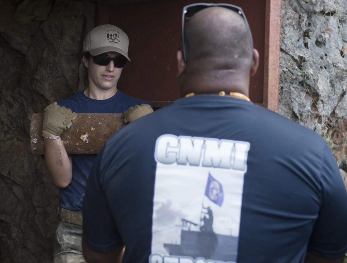 This Jan. 24, 2019 file photo shows Lt. Ana Mansueti, assigned to Explosive Ordnance Disposal Mobile Unit or EODMU 5, Detachment Marianas, gather shell fragments of World War II-era Japanese ordnance for detonation in Saipan.