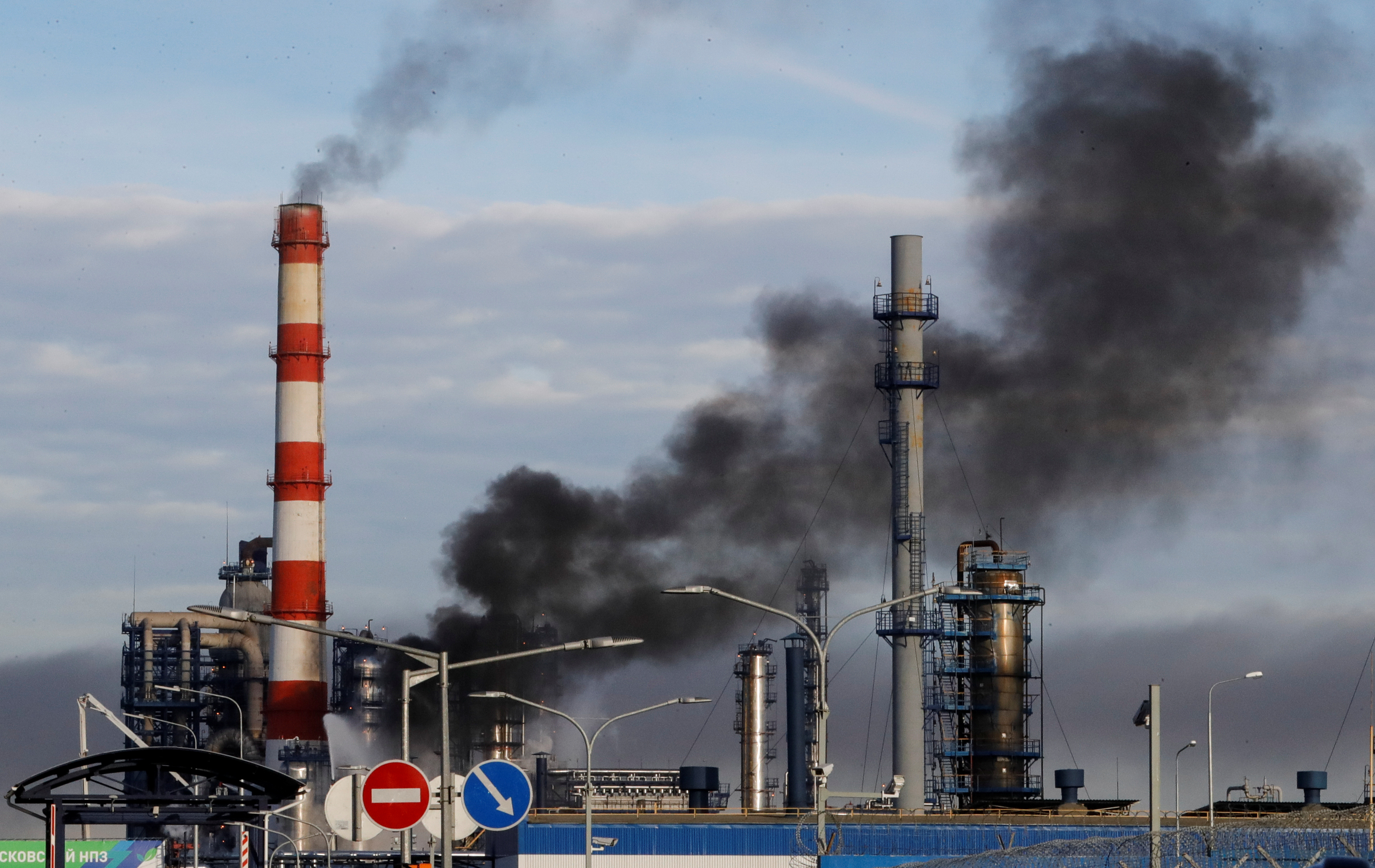 Smoke billows from a fire at oil refinery, owned by Russian oil producer Gazprom Neft, in Moscow, Russia, Nov. 17, 2018.