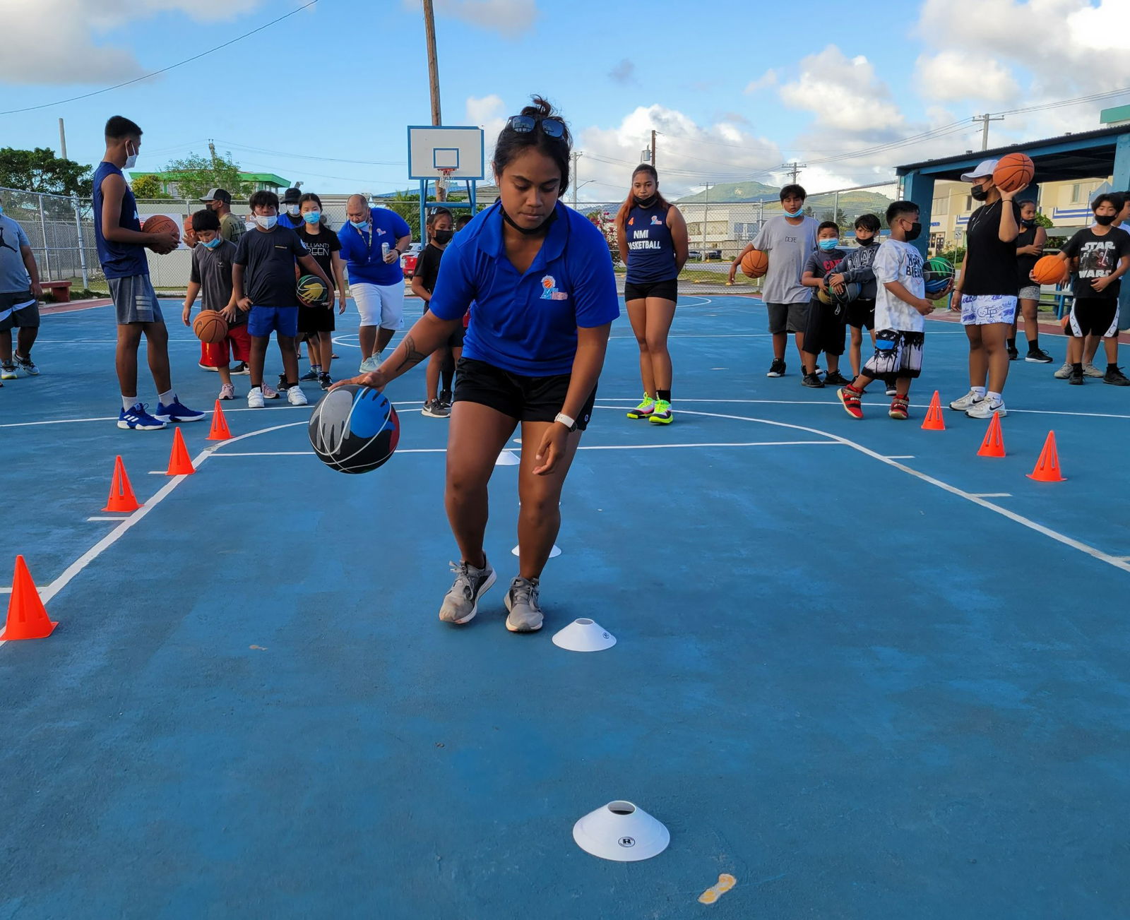 Lia Rangamar gives a rundown of a training routine during a session of the NMI Basketball Federation's Mini Basketball Village Outreach Program or “Bola” earlier this year.