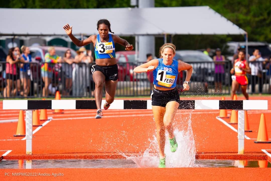 The NMI's Denise Myers, right, makes her way past a water jump during the women's 3000m steeplechase event of the 2022 Pacific Mini Games at the Oleai Track & Field.