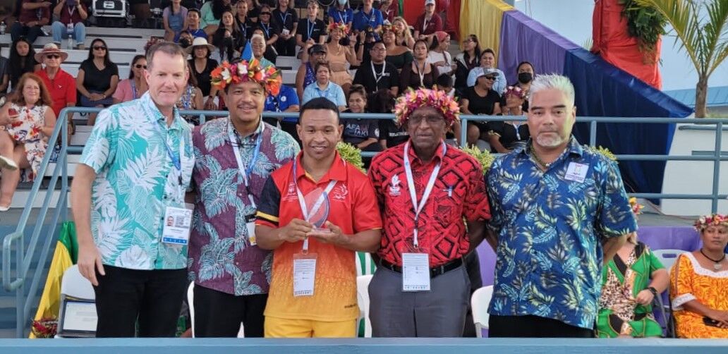 Top Athlete male awardee Morea Baru of Papua New Guinea, center, poses for a photo with Pacific Mini Games CEO Andrew Minogue, acting Gov. Jude Hofschneider, Northern Marianas Pacific Mini Games 2022 CEO Ben Babauta, Pacific Games Council President Vidhya Lakhan, Northern Marianas PMG 2022  Chairman Marco Peter and Northern Marianas Sports Association President Jerry Tan.