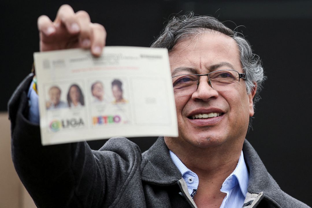 Colombia's Gustavo Petro of the Historic Pact coalition shows his ballot before casting his vote at a polling station during the second round of the presidential election in Bogota, Colombia June 19, 2022.