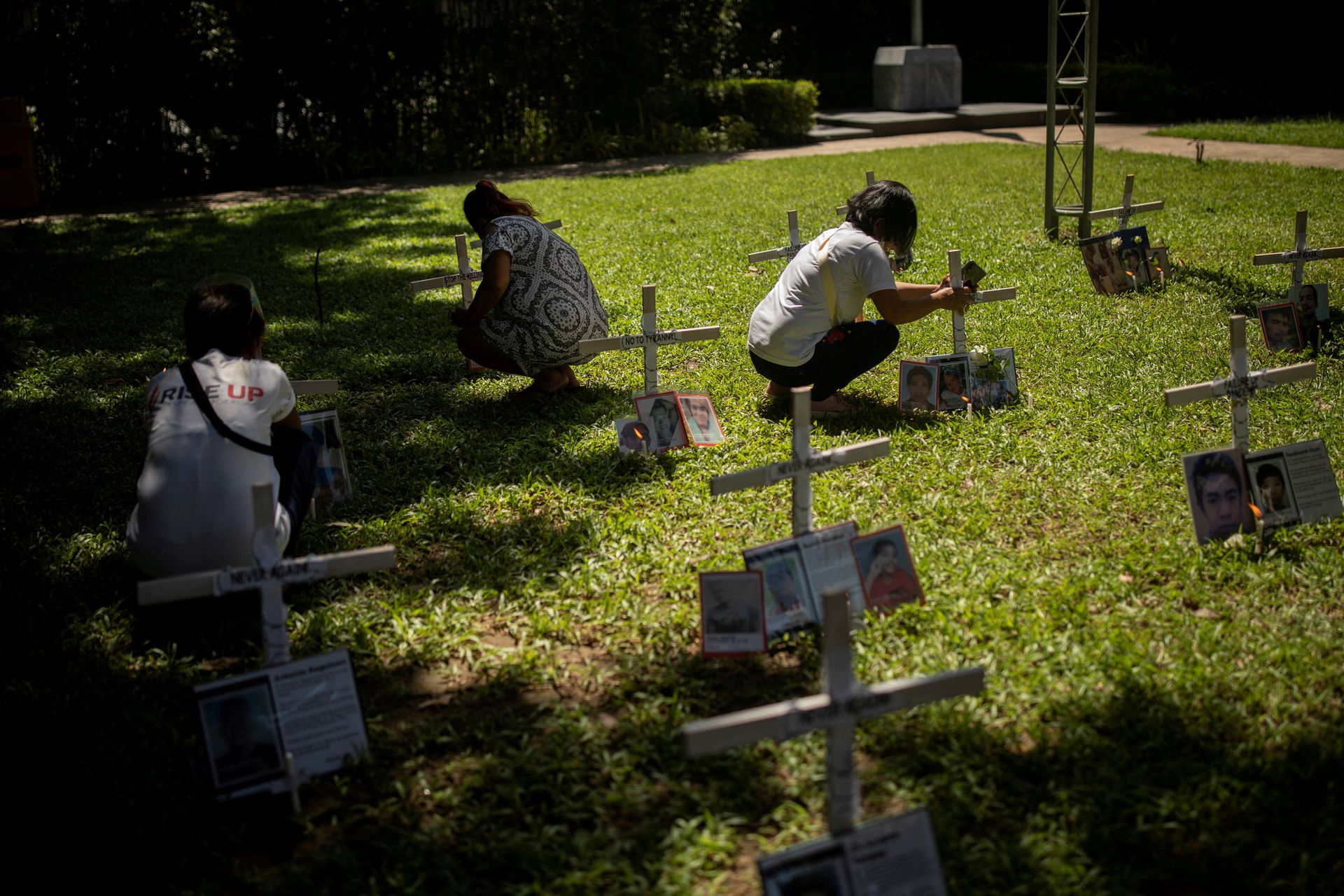 Relatives of drug war victims light candles for their slain loved ones at the Commission on Human Rights where families of drug war victims gathered to pray ahead of All Saints Day, in Quezon City, Metro Manila, Oct. 29, 2021.
