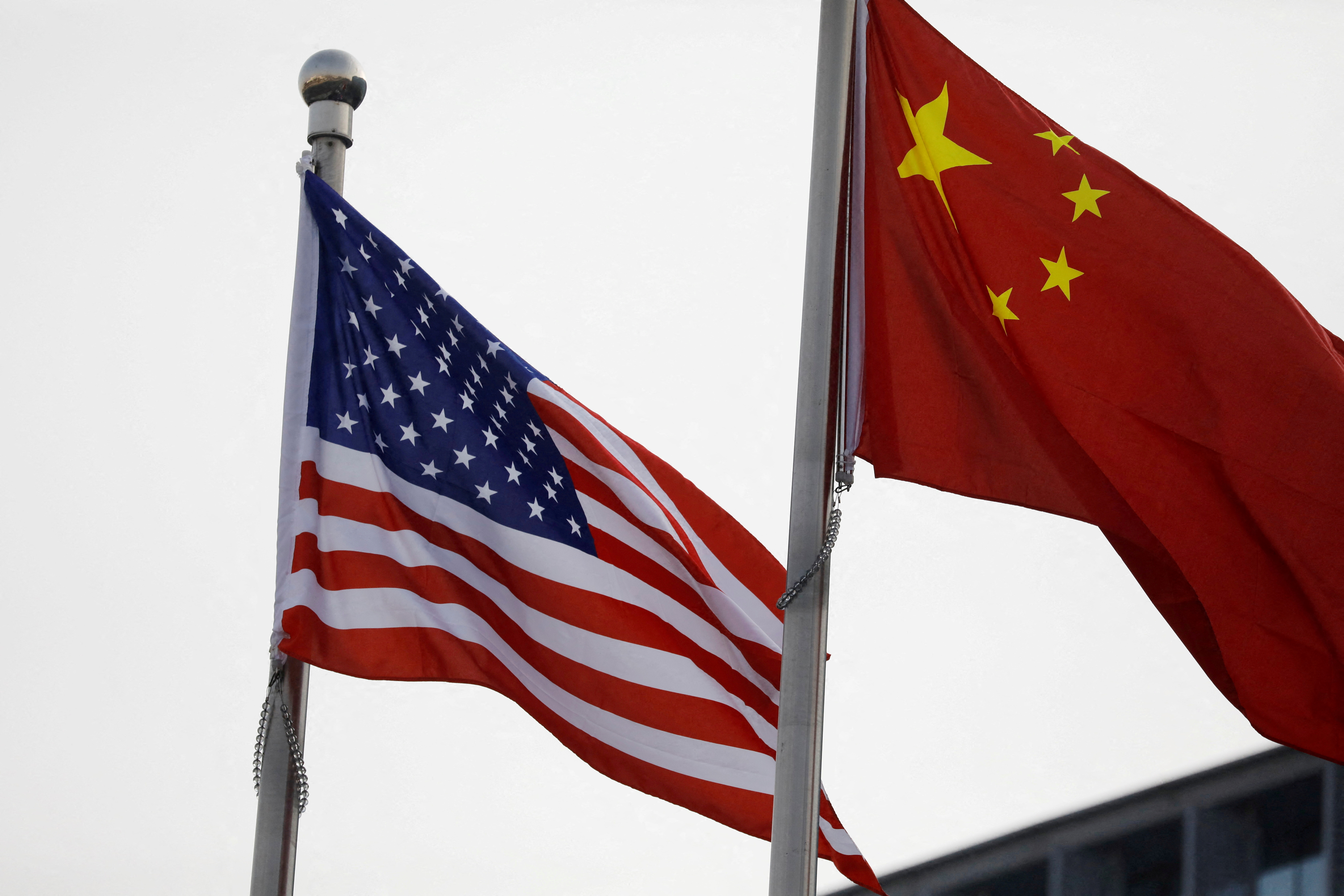 Chinese and U.S. flags flutter outside the building of an American company in Beijing, China on Jan. 21, 2021.