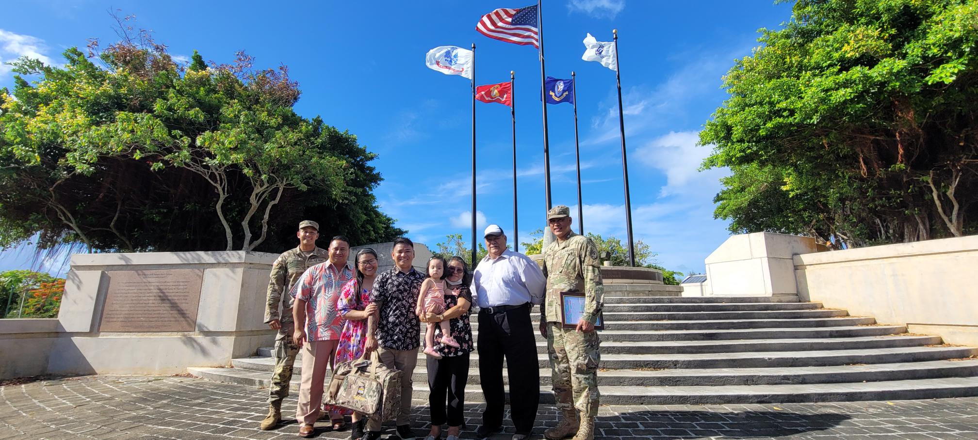 Reyel Quezon, fourth left, poses for a photo with his family, Gov. Ralph DLG Torres, Sgt. Johnovin Diego, and Maj. Juan King at the Court of Honor of American Memorial Park Wednesday.