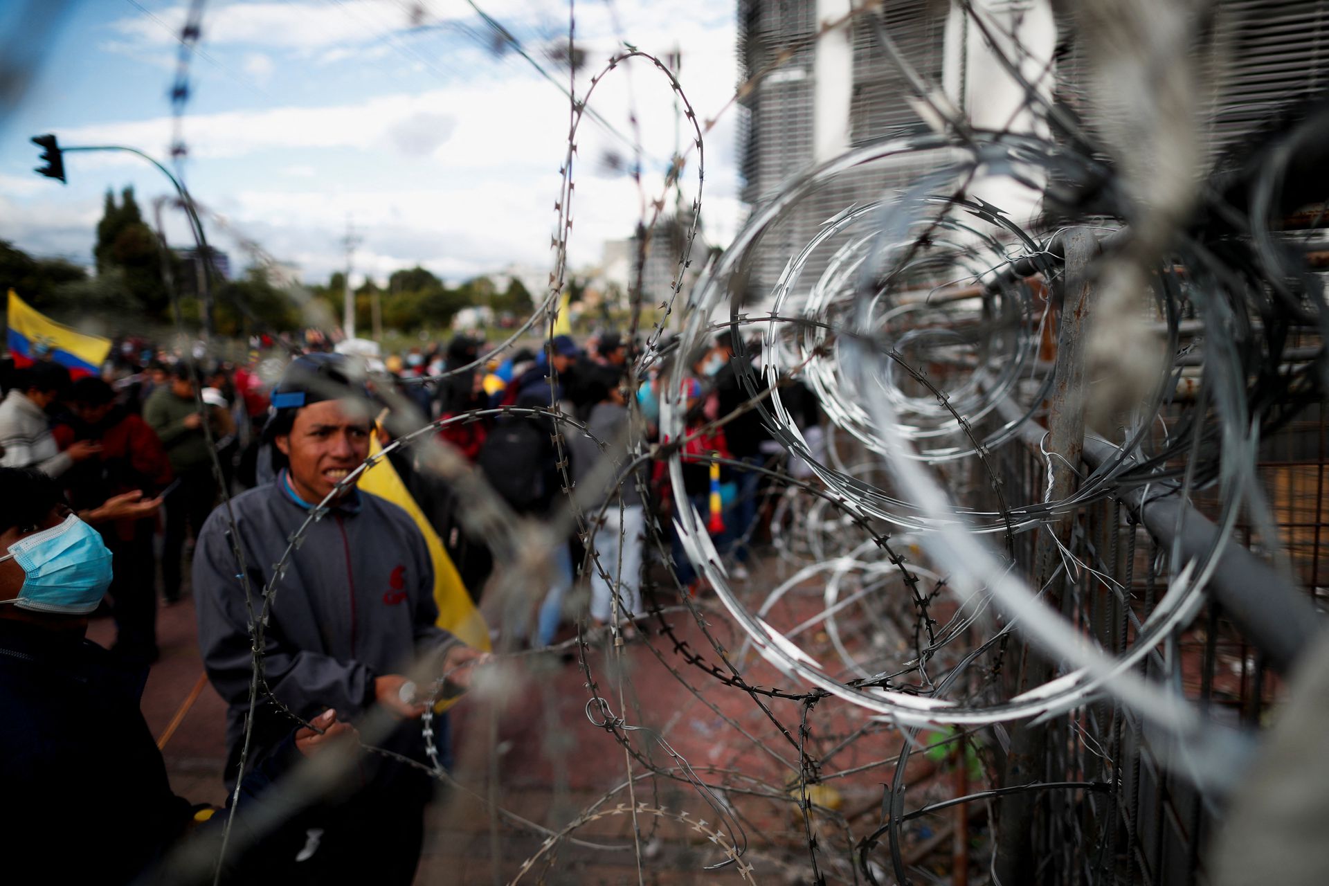 Demonstrators look at a barricade covered in barbed wire as protests continue amid a stalemate between the government of President Guillermo Lasso and largely indigenous demonstrators who demand an end to emergency measures, in Quito, Ecuador on June 26, 2022.