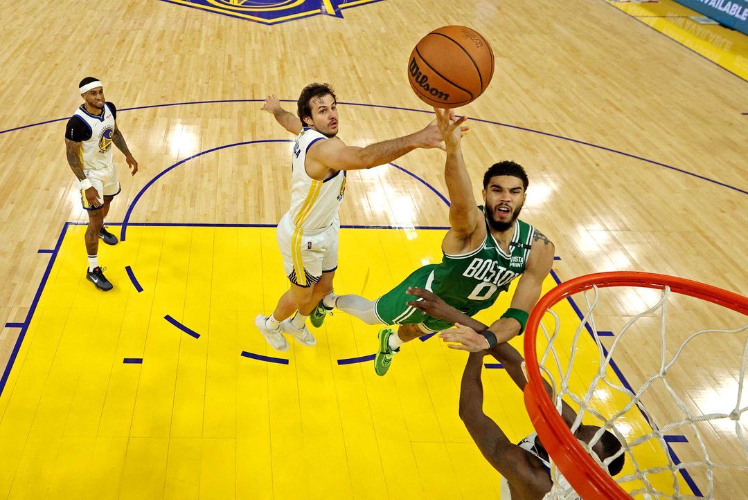 Boston Celtics forward Jayson Tatum (0) shoots the ball against Golden State Warriors forward Draymond Green (23) during game two of the 2022 NBA Finals at Chase Center in San Francisco, California on  June 5, 2022.