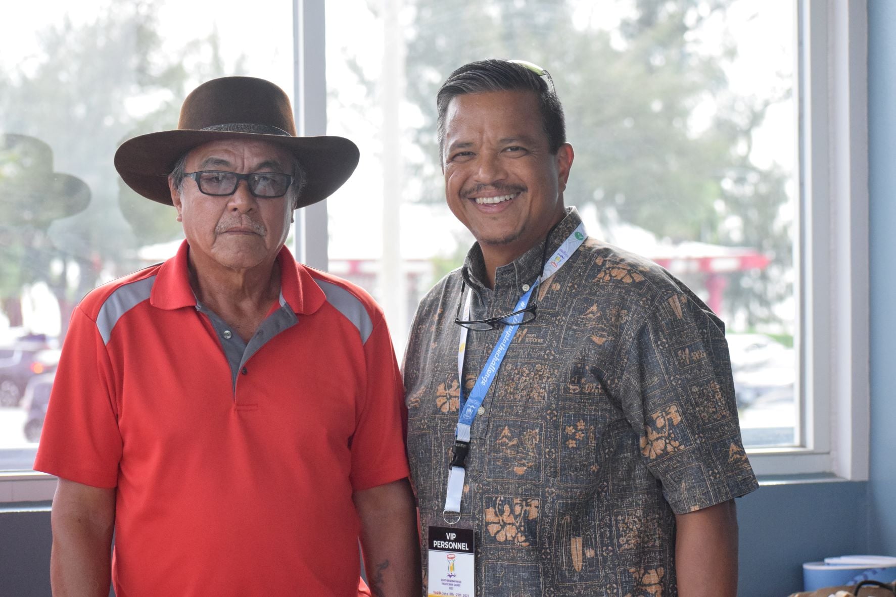 Senate President Jude U. Hofschneider, right, and former Tinian Mayor Ramon M. Dela Cruz, who is also the Tinian Republican Party president, pose for photo in the Francisco "Tan Ko" M. Palacios Baseball Field's press box on Friday.