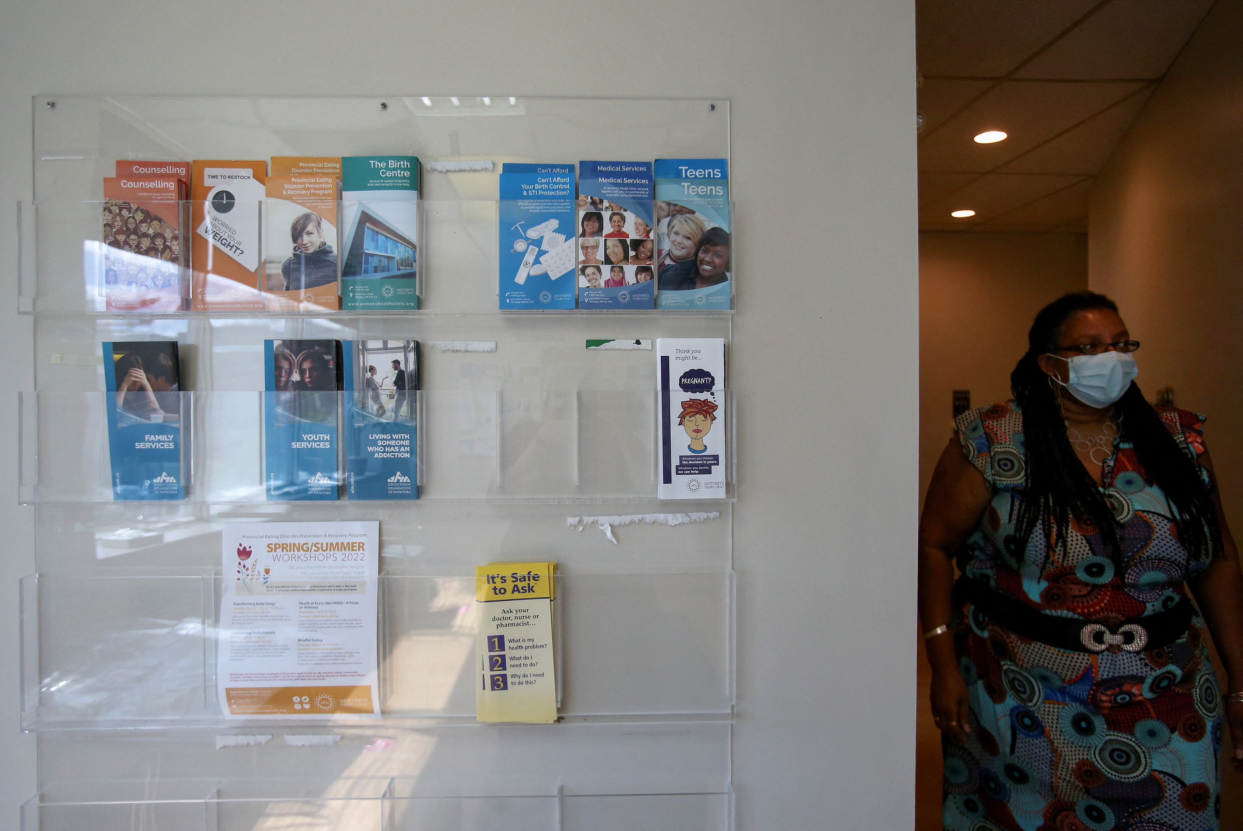 Kemlin Nembhard, executive director at the Women's Health Clinic, which offers reproductive care, including abortions, walks next to information pamphlets at the clinic, in Winnipeg, Manitoba, Canada on June 28, 2022.