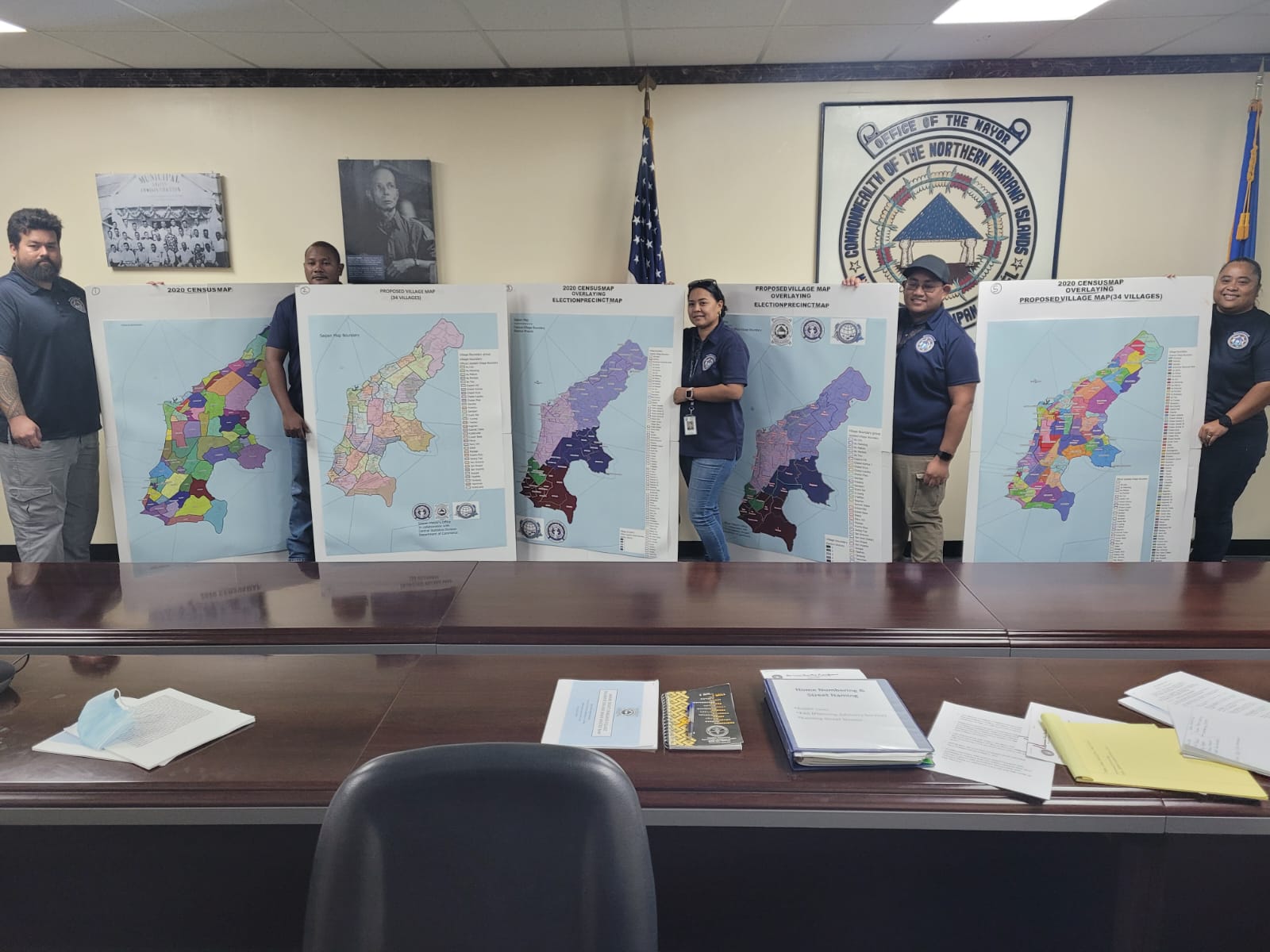 The Saipan mayor’s Street Naming and Numbering Division staffers pose with various maps of the island following a press conference in the mayor's office on Thursday.
