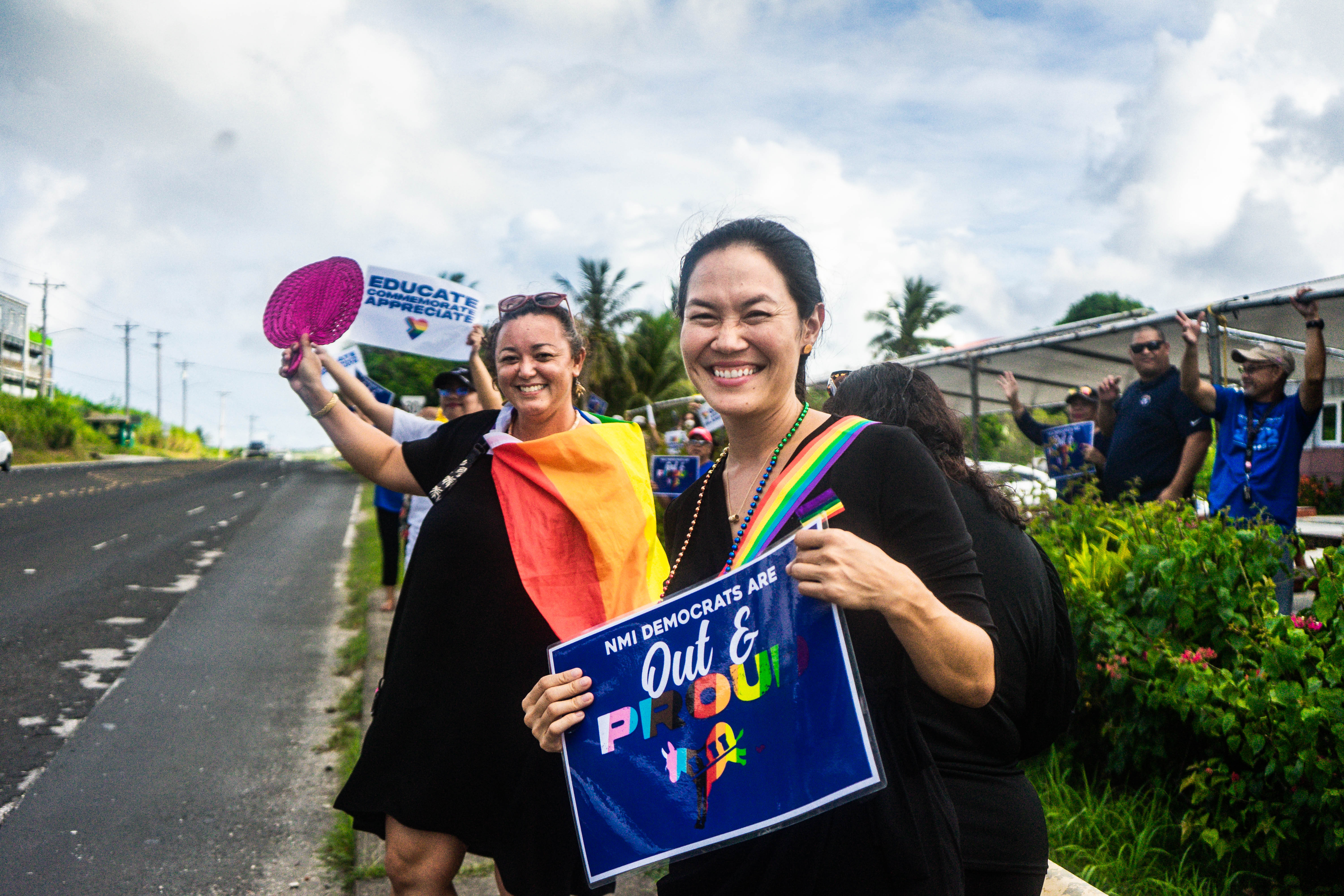 Reps. Tina Sablan and  Leila Staffler wave for PRIDE.